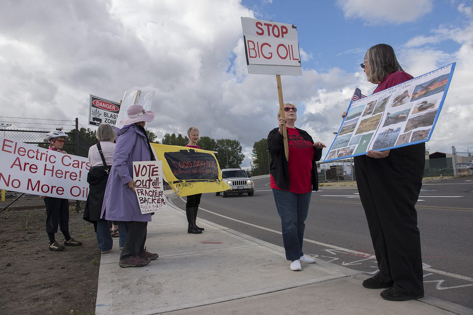 Pat Freiberg, second from right, and Carrie Parks, right, of Beyond Oil and Coal join a handful of fellow protesters near the Port of Vancouver's Terminal 5 on Thursday afternoon, Sept. 17, 2015.