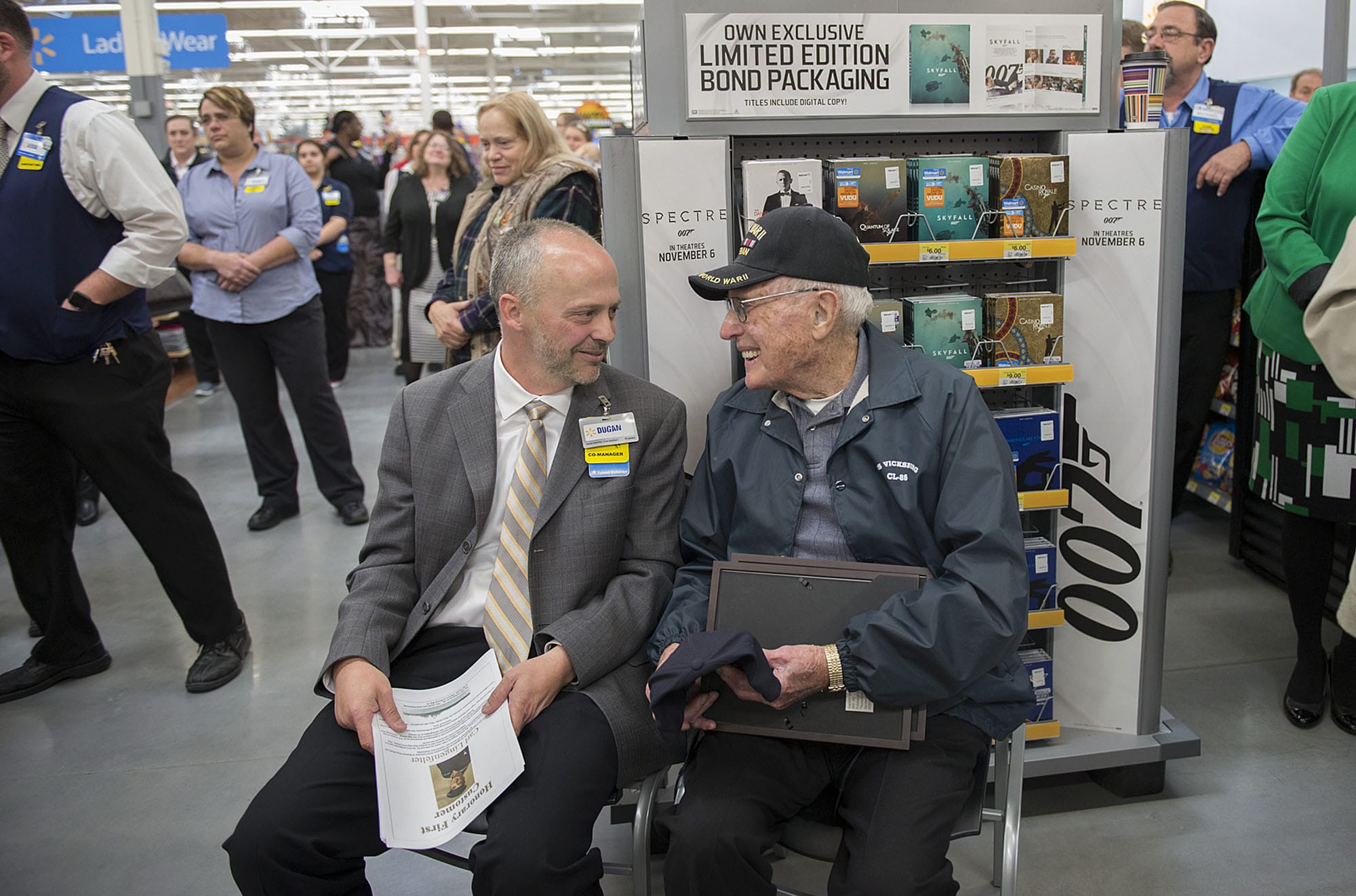 Co-manager Dugan Harris, left, shares a smile with honorary first customer Carl Lingenfelter, who is a World War II veteran, after he was honored Wednesday morning at the new Wal-Mart in Orchards.
