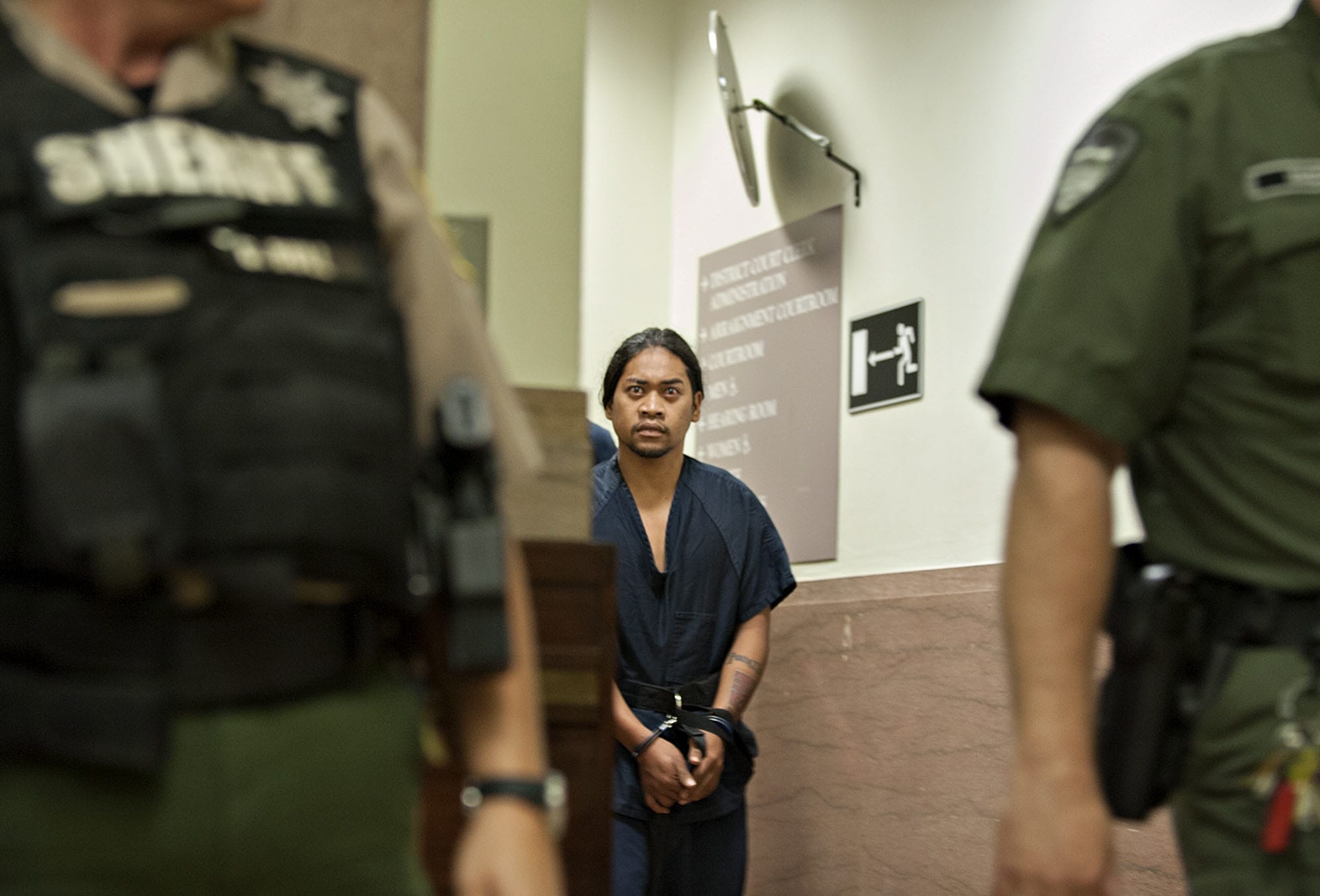 Jacky Chan Karuo of Vancouver makes his way into Clark County Superior Court for a first appearance Wednesday morning, Sept. 2, 2015.