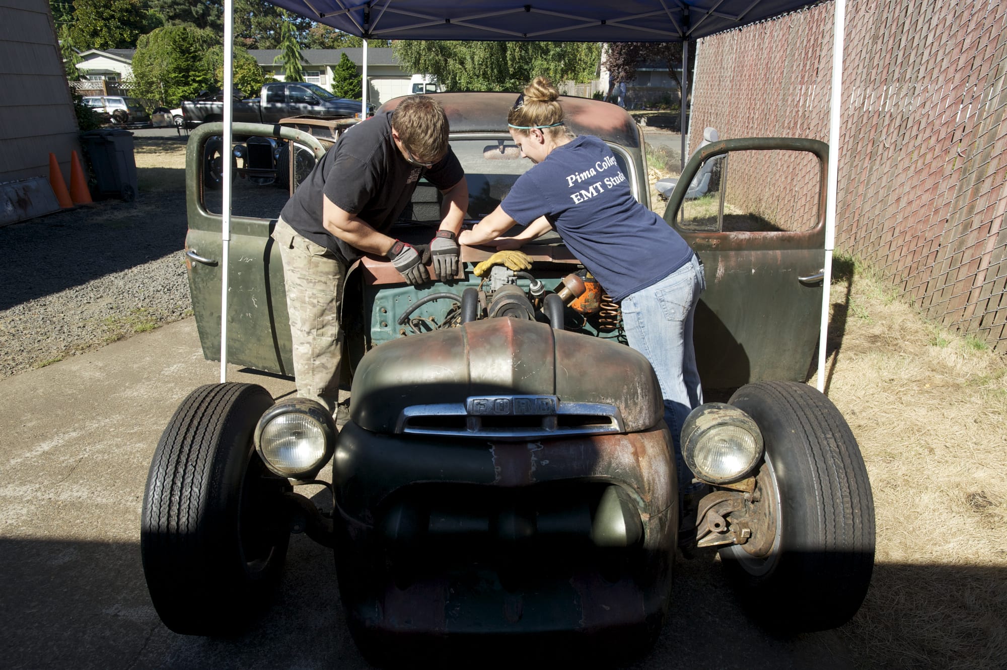David Hubbard, left, and his wife, Jessica Hubbard, work on their Ford rat rod pickup at their home in Vancouver. Hubbard is expected to drive it 300 miles from St.