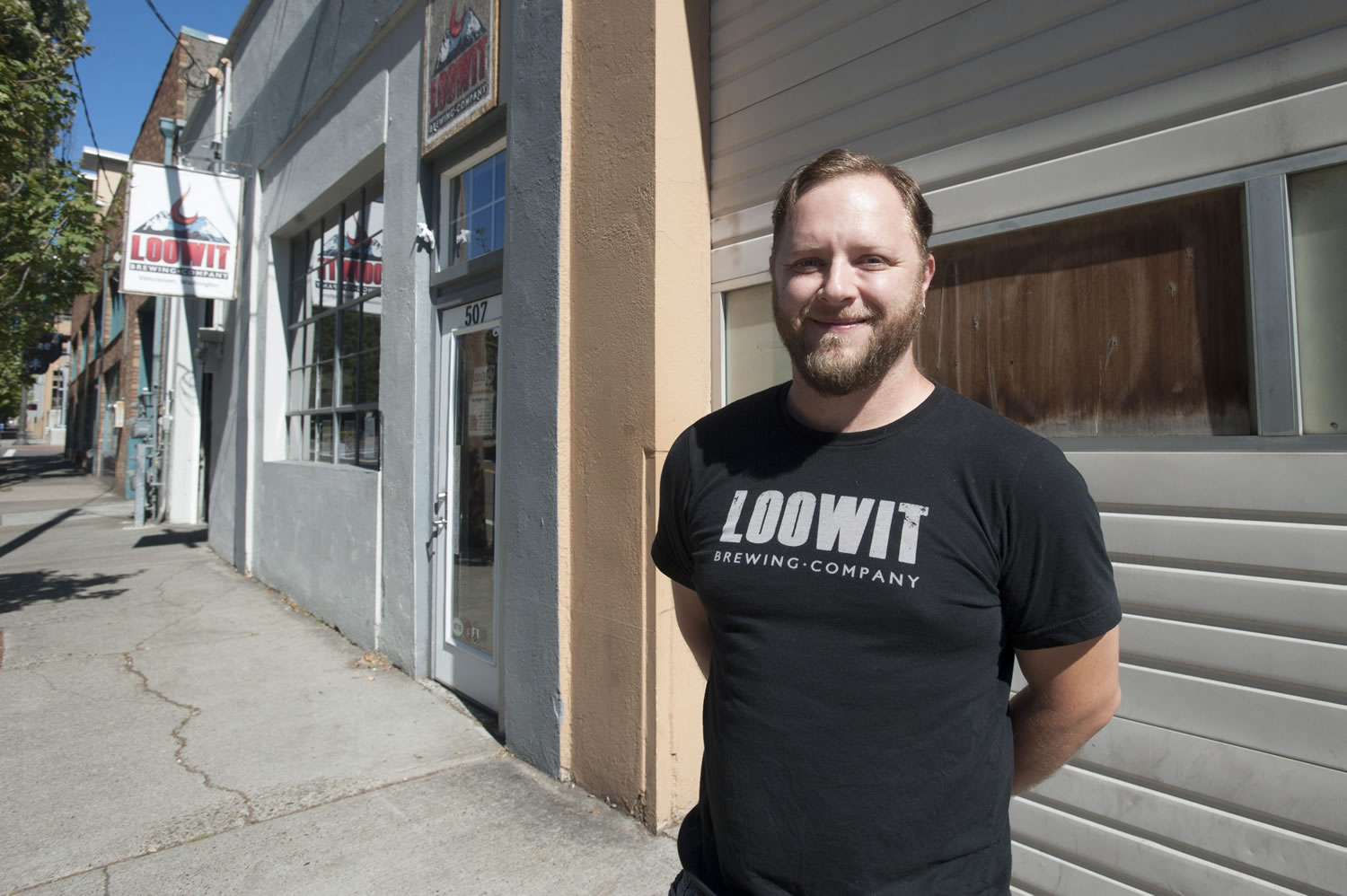 Devon Bray, co-owner of Loowit Brewing, stands in front of his business in downtown Vancouver.
