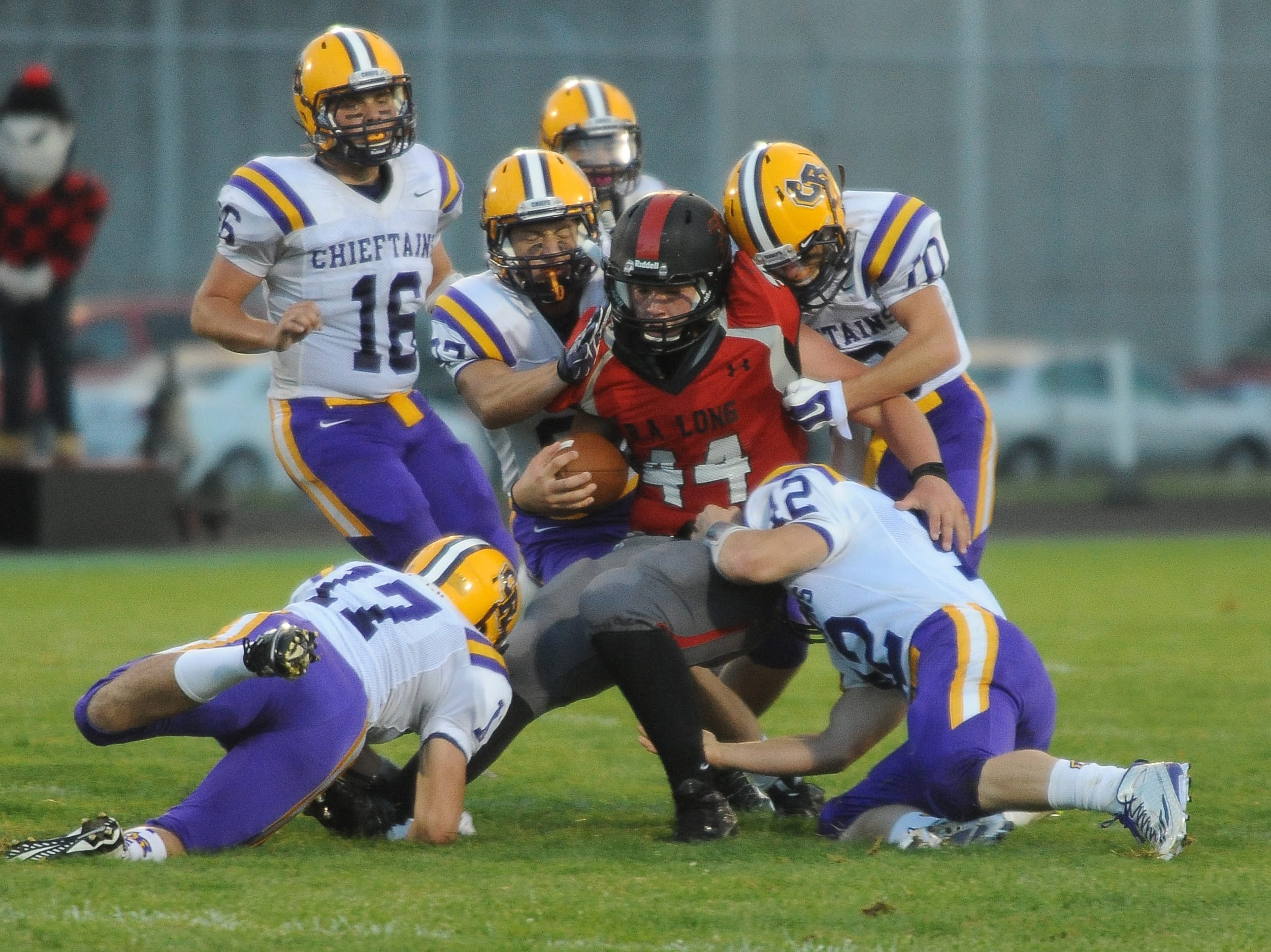 R.A. Long running back Gunnar Blix is tackled by Columbia River players during the first half Thursday in Longview.