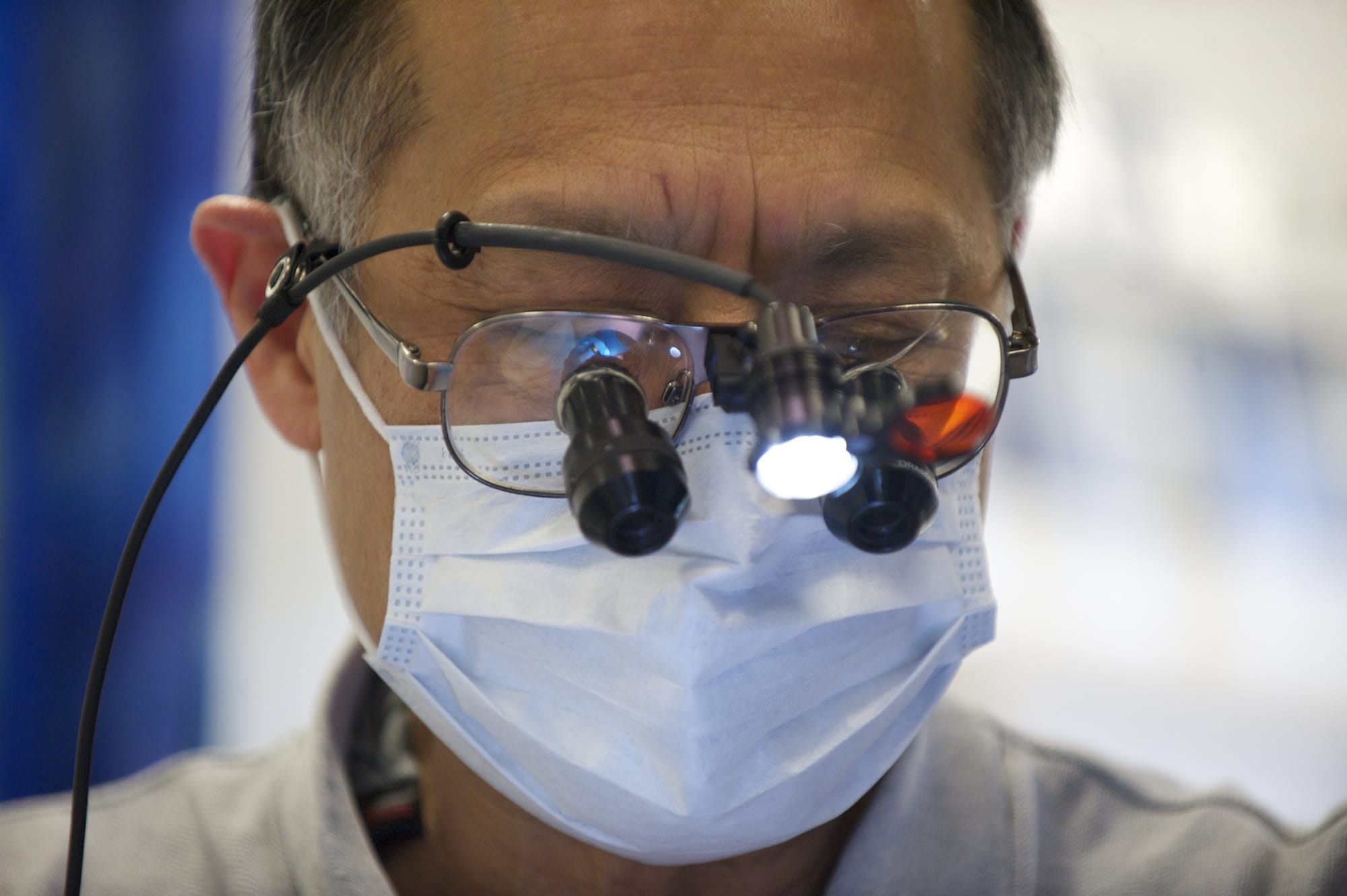 Dentist Eugene Sakai works on a patient in the Free Clinic of Southwest Washington's dental van Friday.