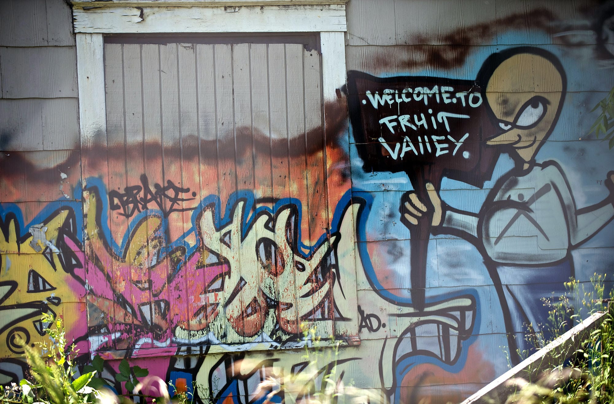 Graffiti on a longtime problem house on Fruit Valley Road was the subject of an order by the city of Vancouver, requiring owner Paul Johnston to bring the building up to code or it will be demolished.