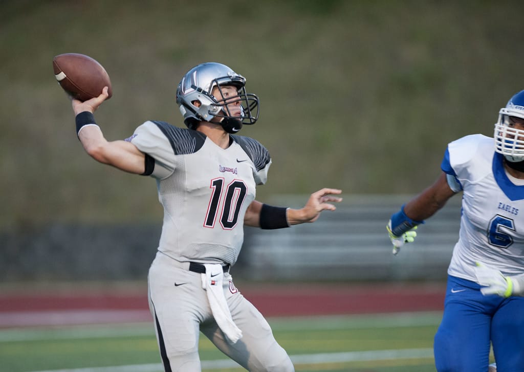 Union High School's Jordan Lawson (10) throws while under pressure from Federal Way's Andrzej Hughes-Murray in the second quarter Friday night, Sept.4, 2015 at McKenzie Stadium.