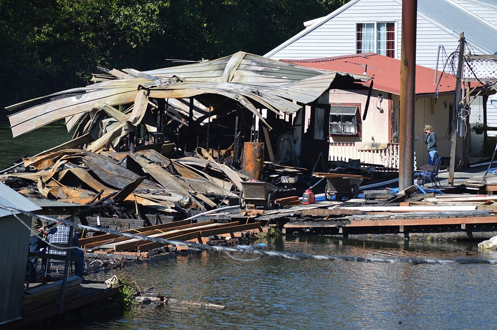 A fire destroyed at least two floating homes at Kadow's Catapiller Island Marina off Lower River Road Sunday night. Workers were trying to rebuild part of the dock, which also burned, Monday afternoon.