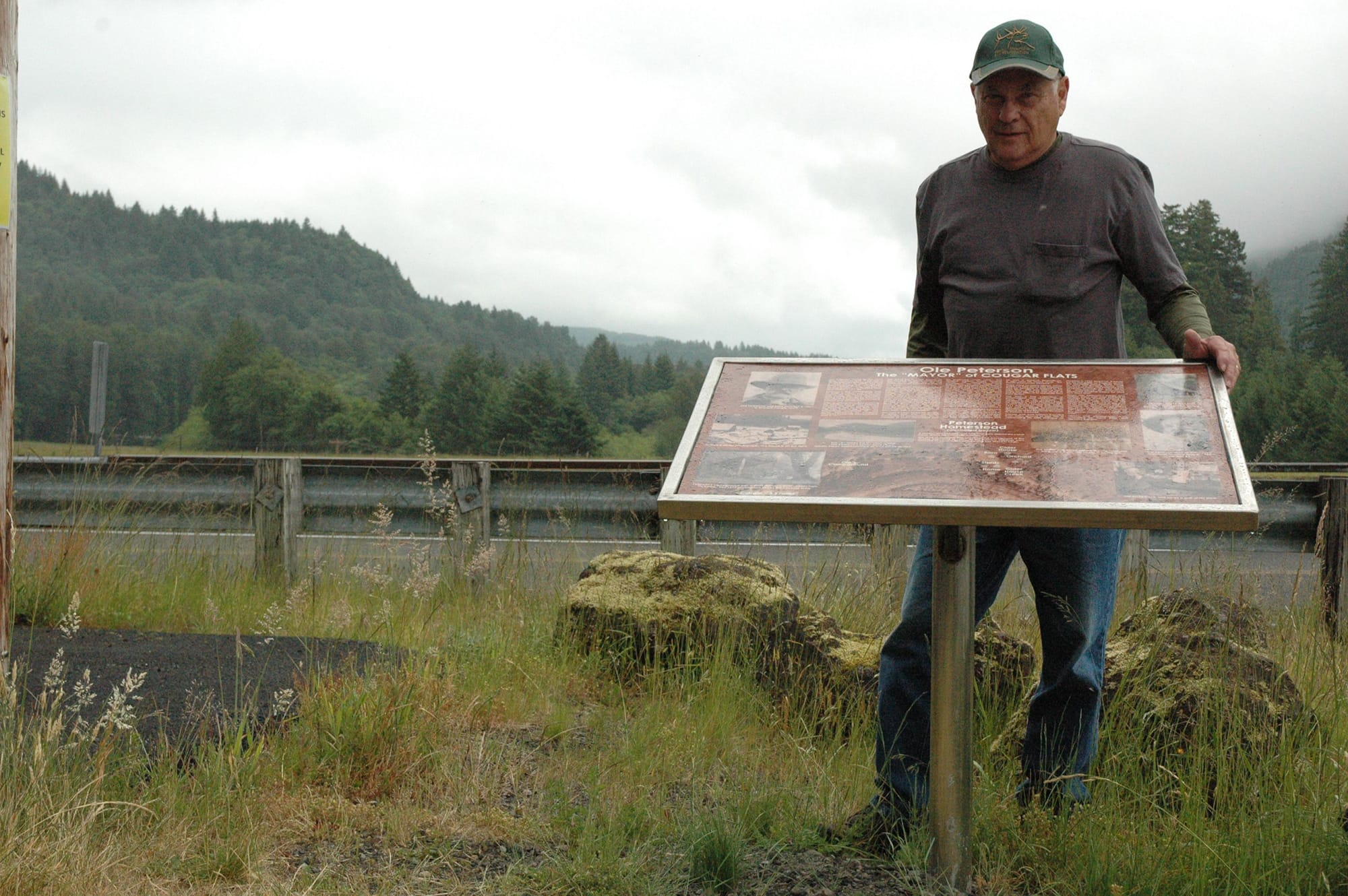 Amateur historian Gene Ritter of Vancouver stands with a newly placed historical marker along Lewis River Road at the Swift Power Canal in Skamania County.