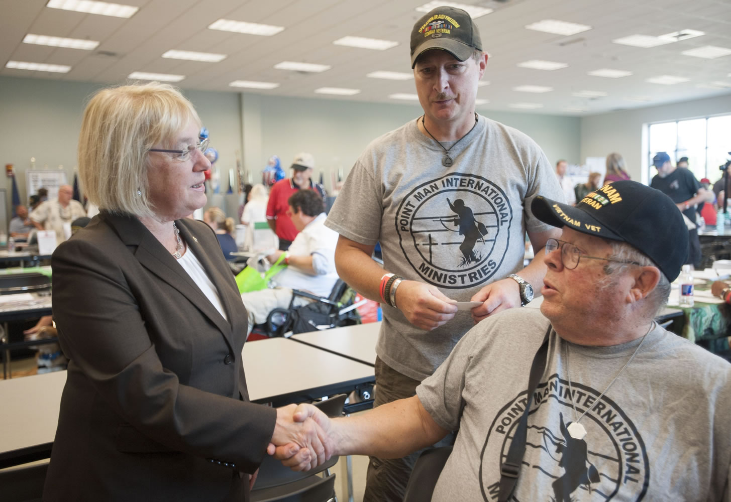 Sen. Patty Murray meets with veterans Clint McCourtney, right,  and Paul Sluznis at the annual veterans stand-down in Vancouver on Aug.