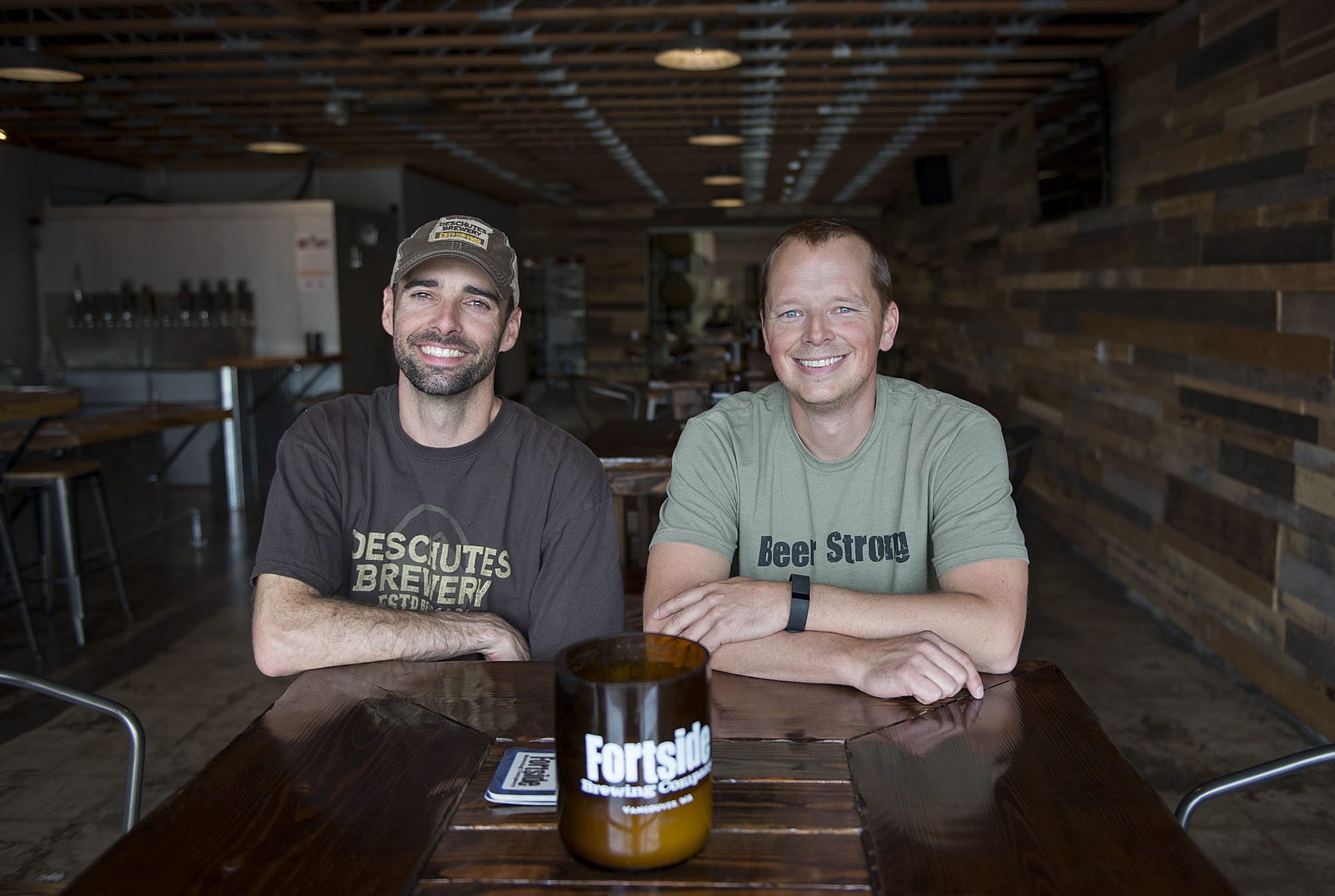 Fortside Brewing Company co-owners Mark Doleski, left, and Mike DiFabio chat in their Vancouver tasting room. The two men, former classmates at Prairie High School, are preparing for Fortside’s grand opening celebration that begins Thursday.