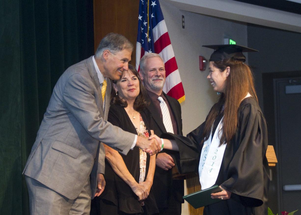 Washington State Gov. Jay Inslee congratulates Maria De Jesus Preciado Reina at the commencement ceremony Thursday at Washington School for the Deaf. In his address, Inslee told the students, &quot;You're heroes. Good luck!