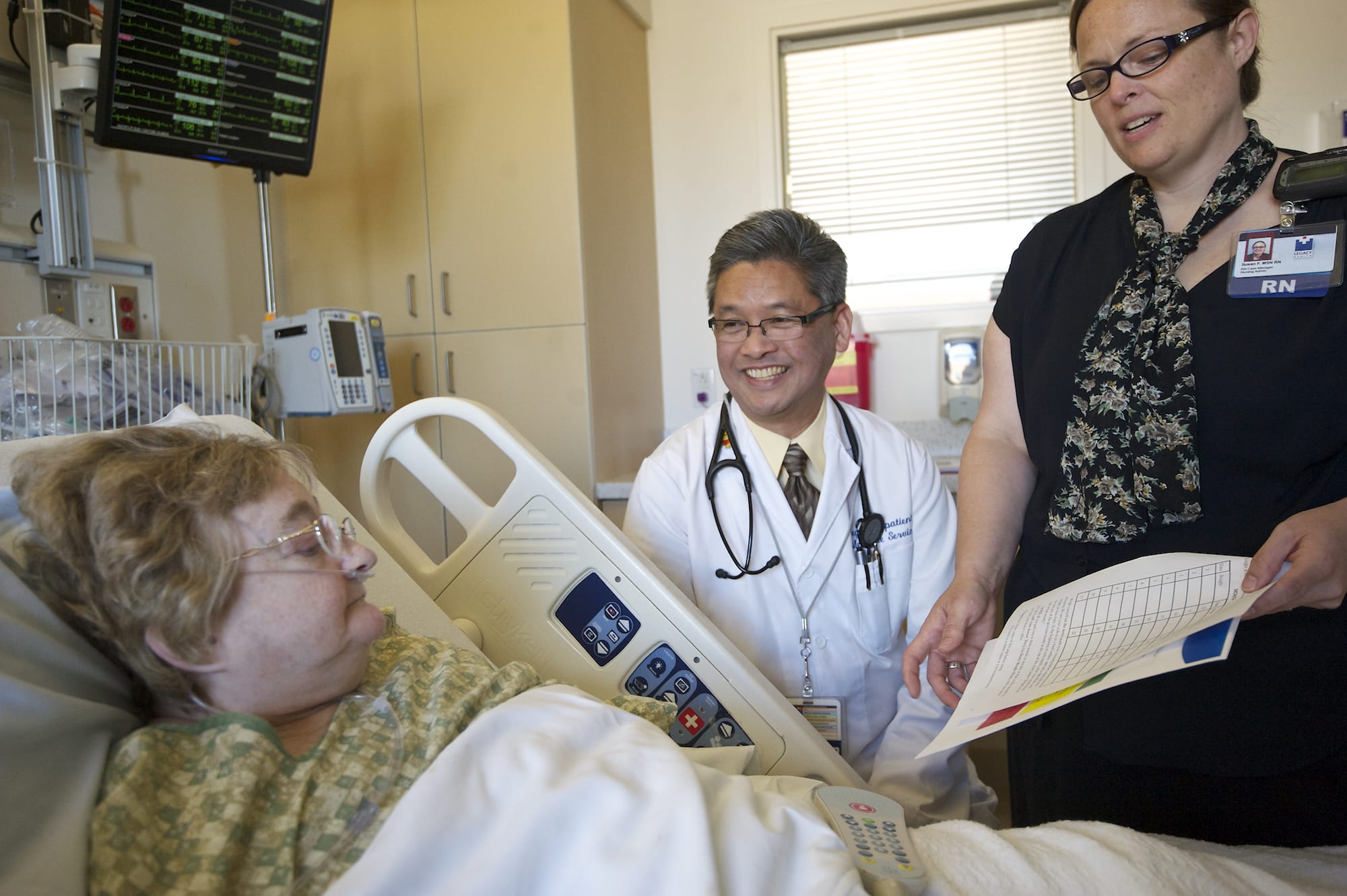 Dr. Hoa Ly, center, and registered nurse Susan Frederick discuss follow-up instructions with heart failure patient Marilyn Wright, 64, of Vancouver before discharging her from Legacy Salmon Creek Medical Center on Wednesday.
