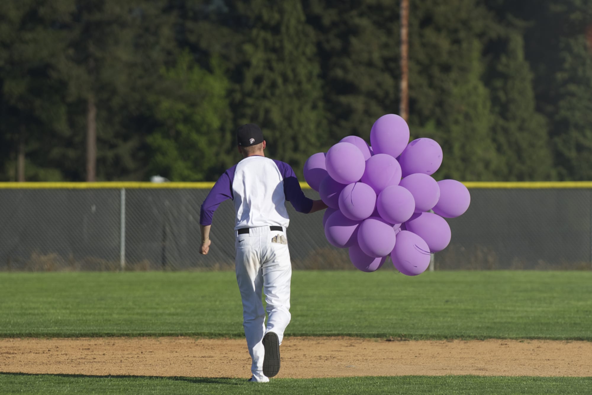 Union High School's Tyler White released purple balloons -- the color for Hodgkin lymphoma awareness -- after Wednesday's victory over Battle Ground.
