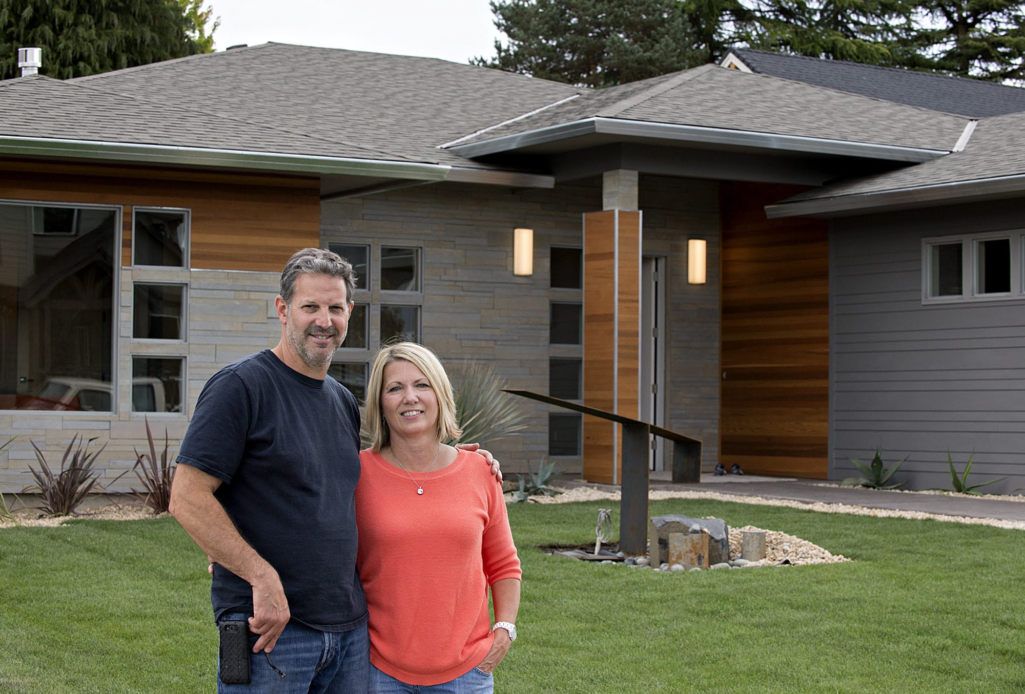 John Taylor, owner of Modern Home Design & Build, and his wife, Julie Wilcox, stand in front of The Hyfield, one of five homes included in this year’s NW Natural Parade of Homes, which opens Friday and runs through Sept. 20. Taylor says his home designs are reminiscent of the midcentury architecture of Southern California.