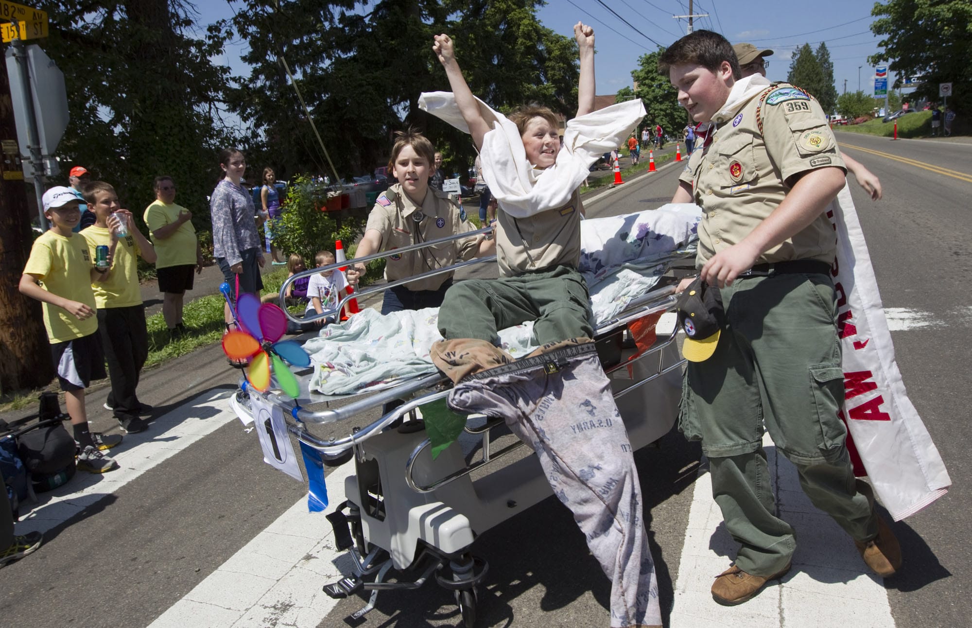 Jackson Sinclair, center, of Boy Scout Troop 359 celebrates as his team crosses the finish line during Saturday's bed races at Hockinson Fun Days.