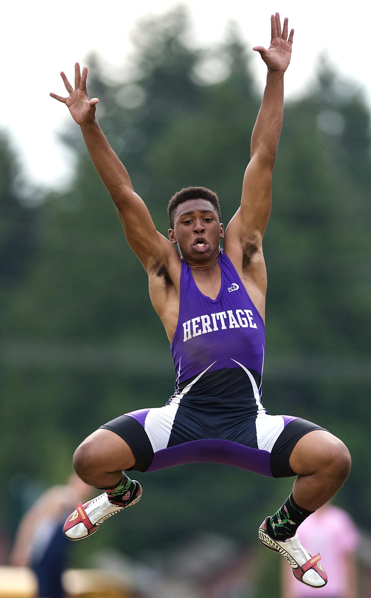 Heritage High School's Devin Murphy jumps 21 feet, 7.5 inches to win the 4A long jump at the district track meet at McKenzie Stadium on Thursday.