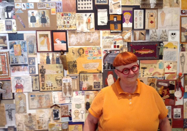 Artist Mar Goman stands before &quot;The Wall,&quot; a series of postal art she sent to her friend Jack Danger over the past 15 years, which is on display at her new show at North Bank Gallery through May 31.