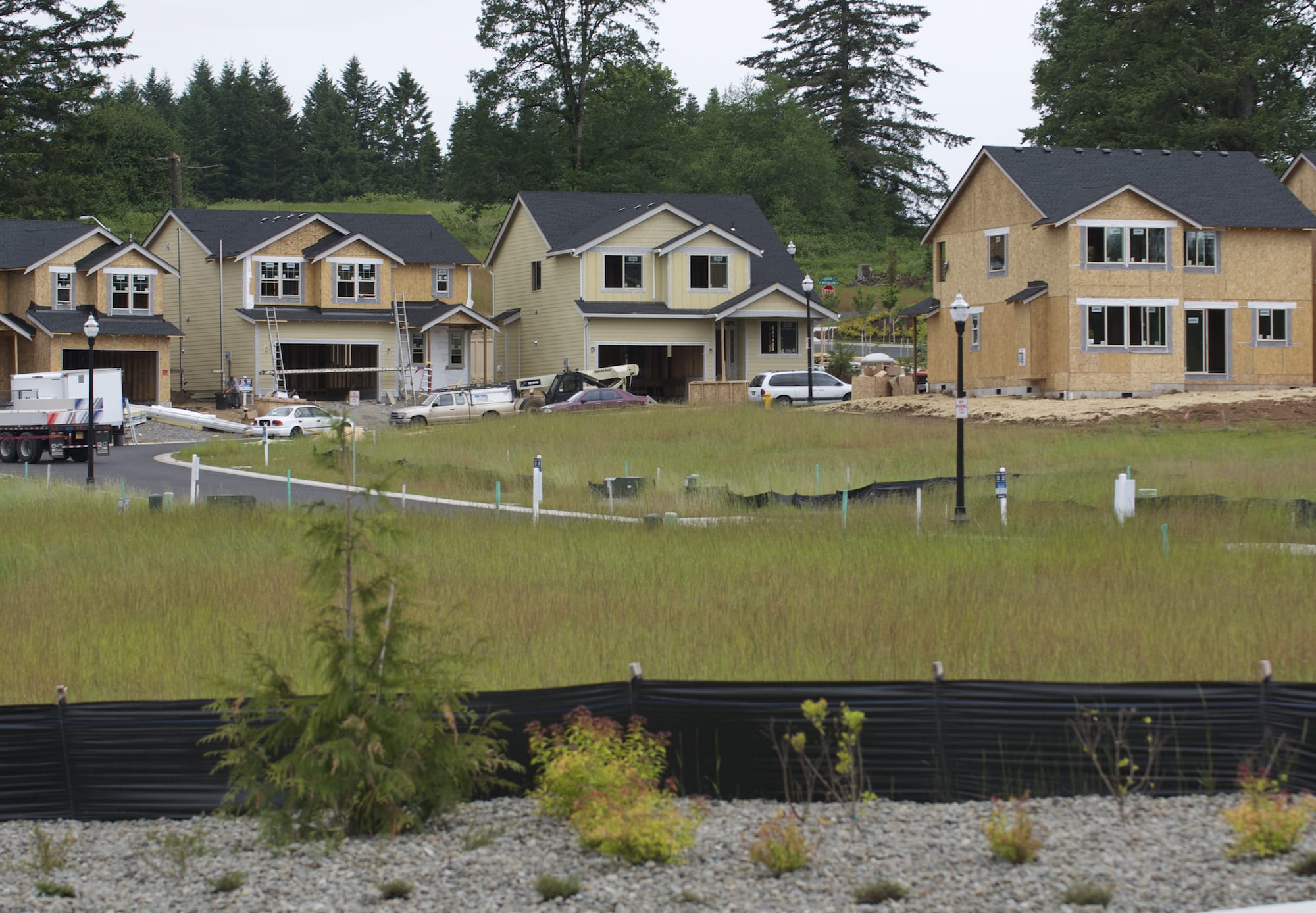 Crews work at the Hills at Round Lake, a new 333-lot housing development in Camas.