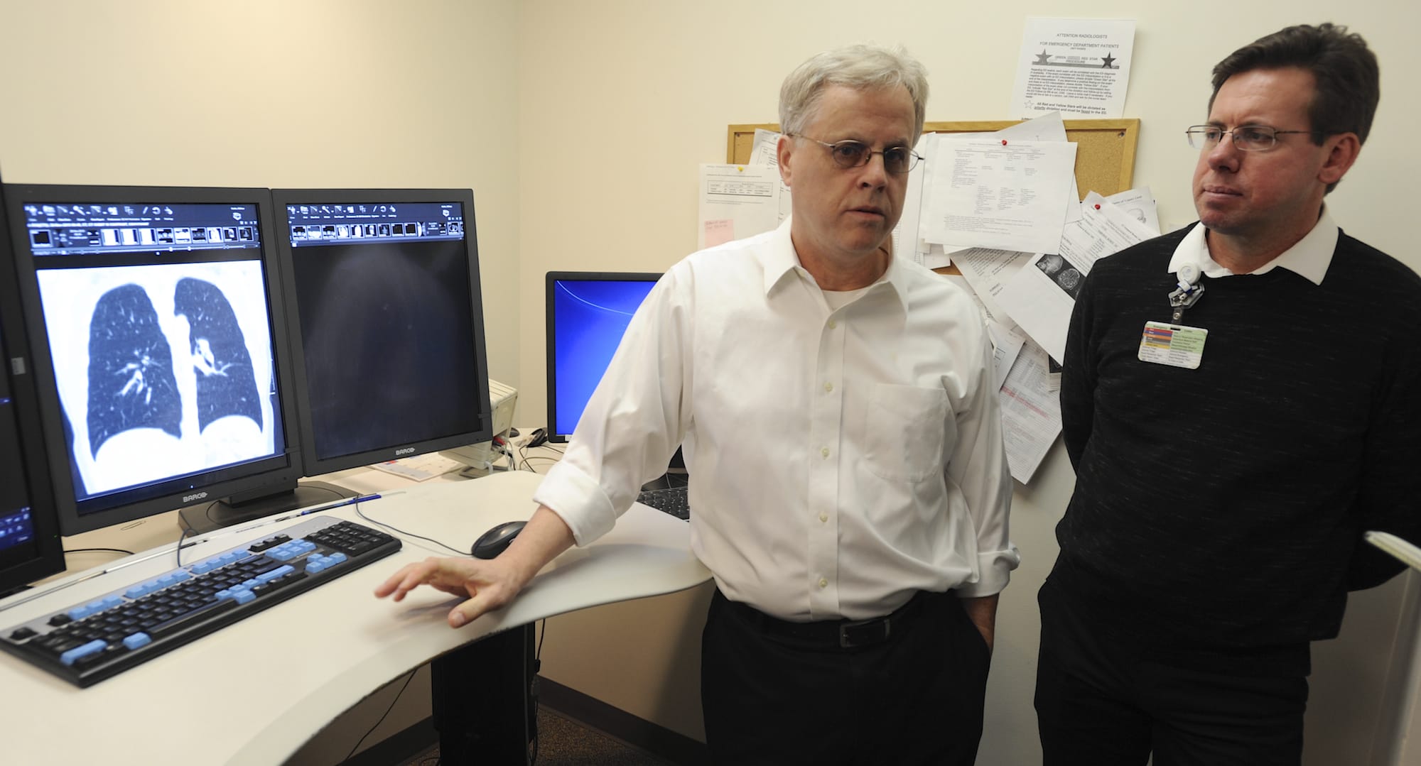 Radiologist William Kuhle, left, and Dr. Michael Myers, a radiation oncologist, discuss a new lung cancer screening program to roll out next month at PeaceHealth Southwest Medical Center in Vancouver. The program will follow the first lung cancer screening recommendations implemented in the U.S.