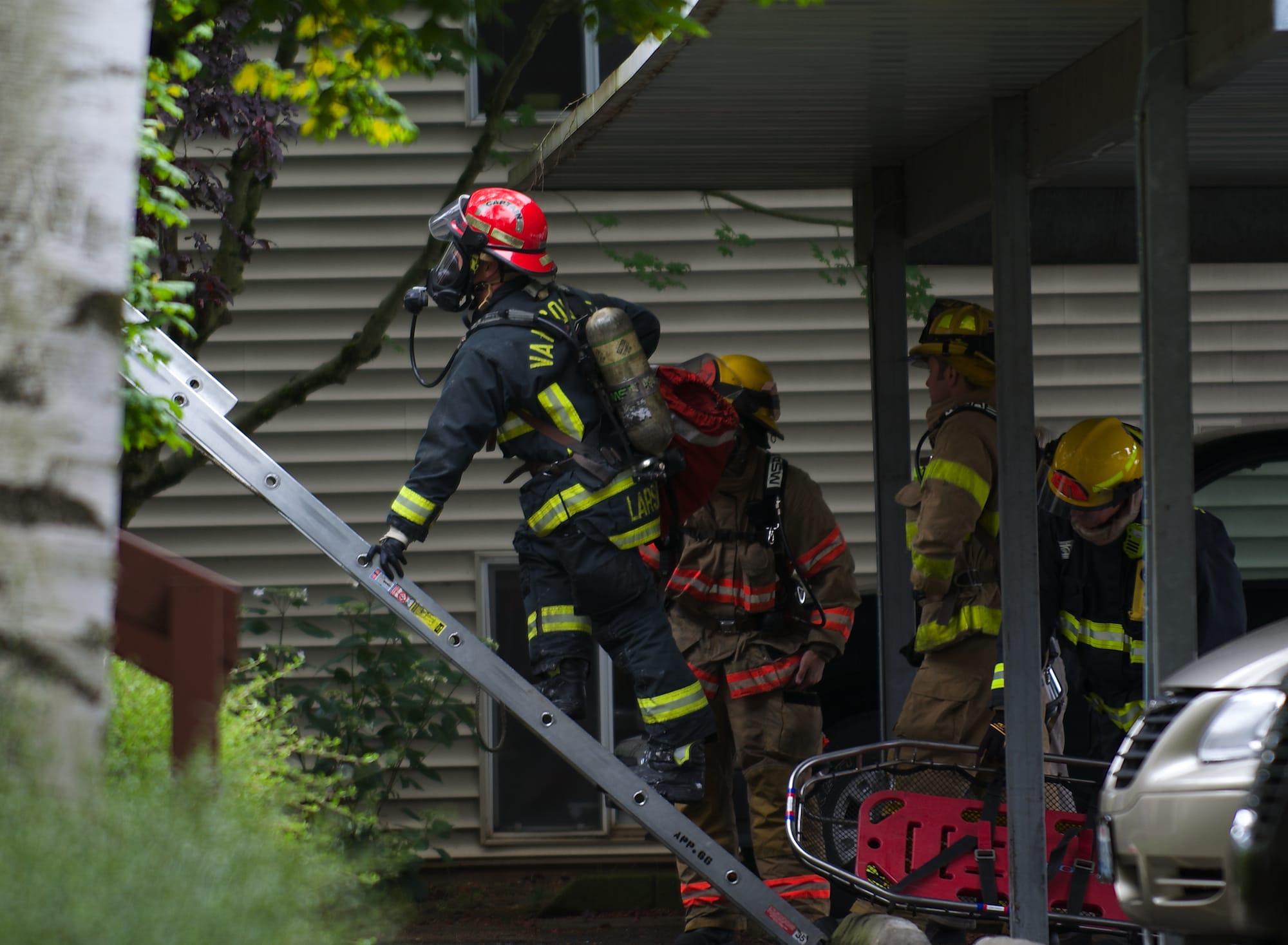 Vancouver firefighters prepare to recover a body from an apartment complex on Thursday in Vancouver after an early-morning fire.