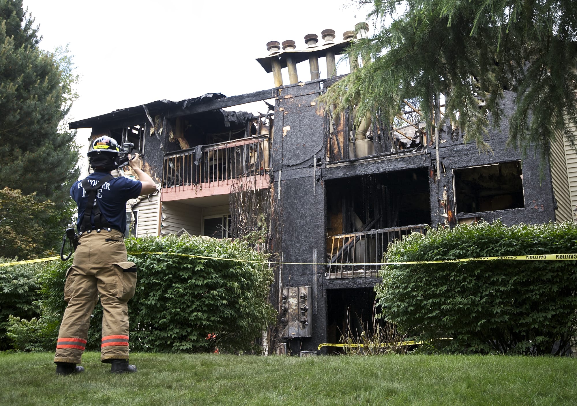 Fire officials investigate a fatal fire at the Sunpointe Apartments on Thursday.