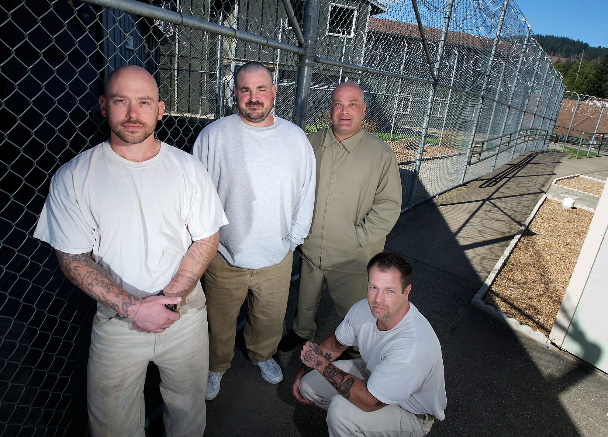 Larch Corrections Center offenders Michael Skinner, from left, Clayton Chapin, Walt Beasley, and Marcus Smith gather Friday to discuss their roles as part of a 17-man crew that helped feed rescue and recovery workers for two weeks at the scene of the massive March 22 landslide near Oso.
