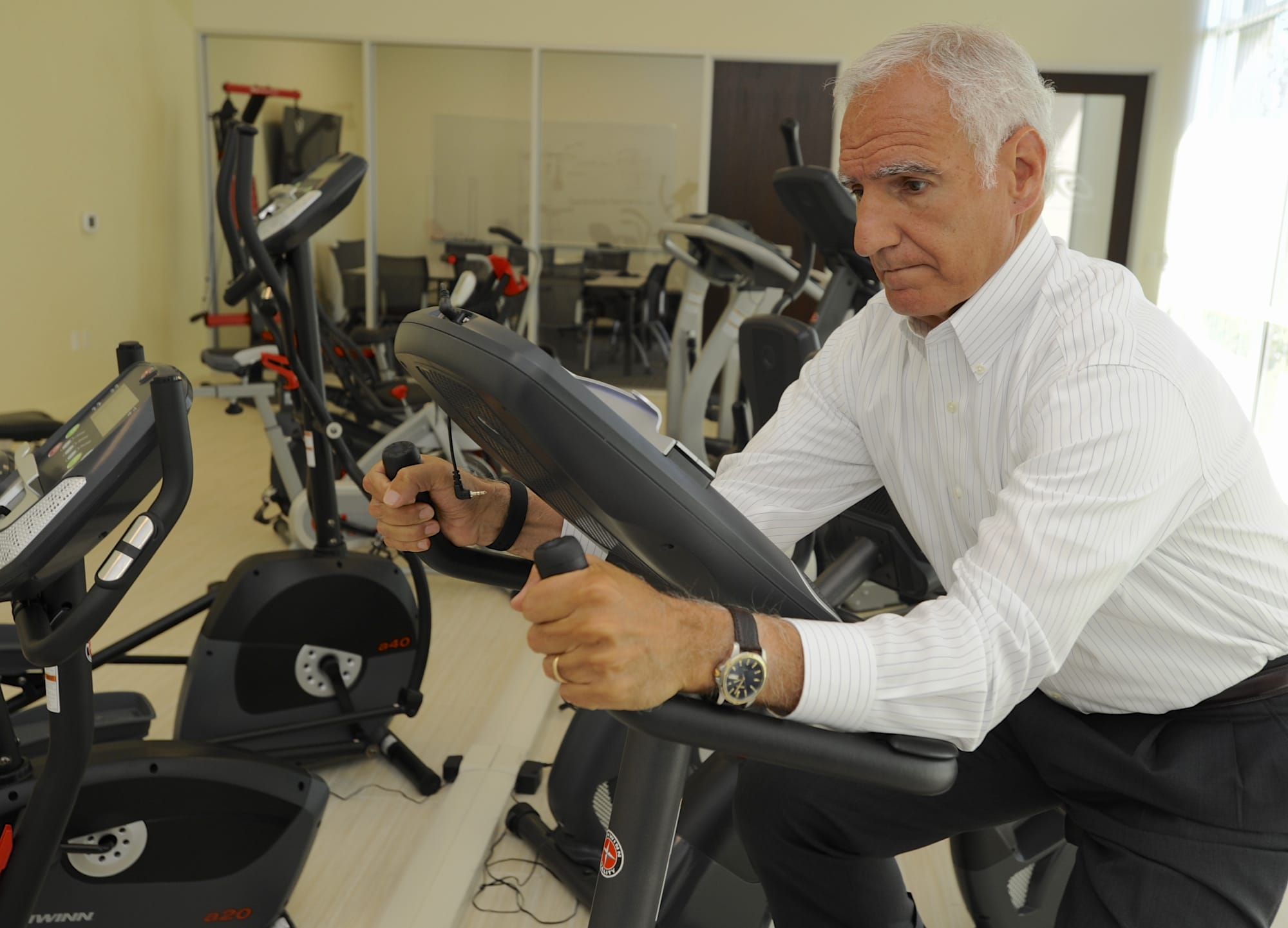 Nautilus CEO Bruce Cazenave demonstrates the features of the new Schwinn upright bike in the showroom at the new headquarters of Nautilus in Vancouver.