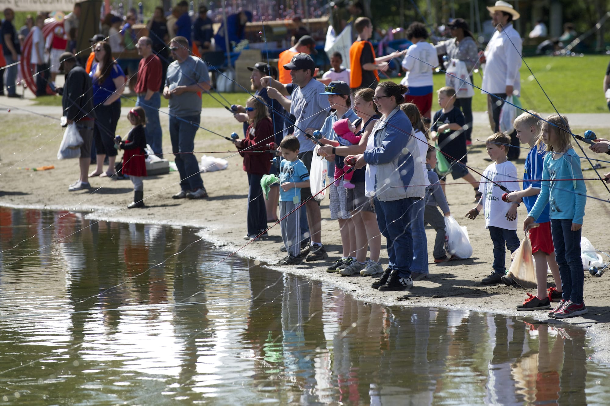 Photos by Steven Lane of The Columbian
Kids of all ages drop a line during the Klineline Kids Fishing Derby Saturday at Klineline Pond in Vancouver.