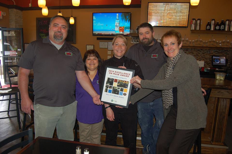 Camas: Downtown Camas Association Executive Director Carrie Schulstad presents Mill City Brew Werks owners and staff with the Excellence on Main Street Economic Vitality Award from the Washington State Main Street Program.