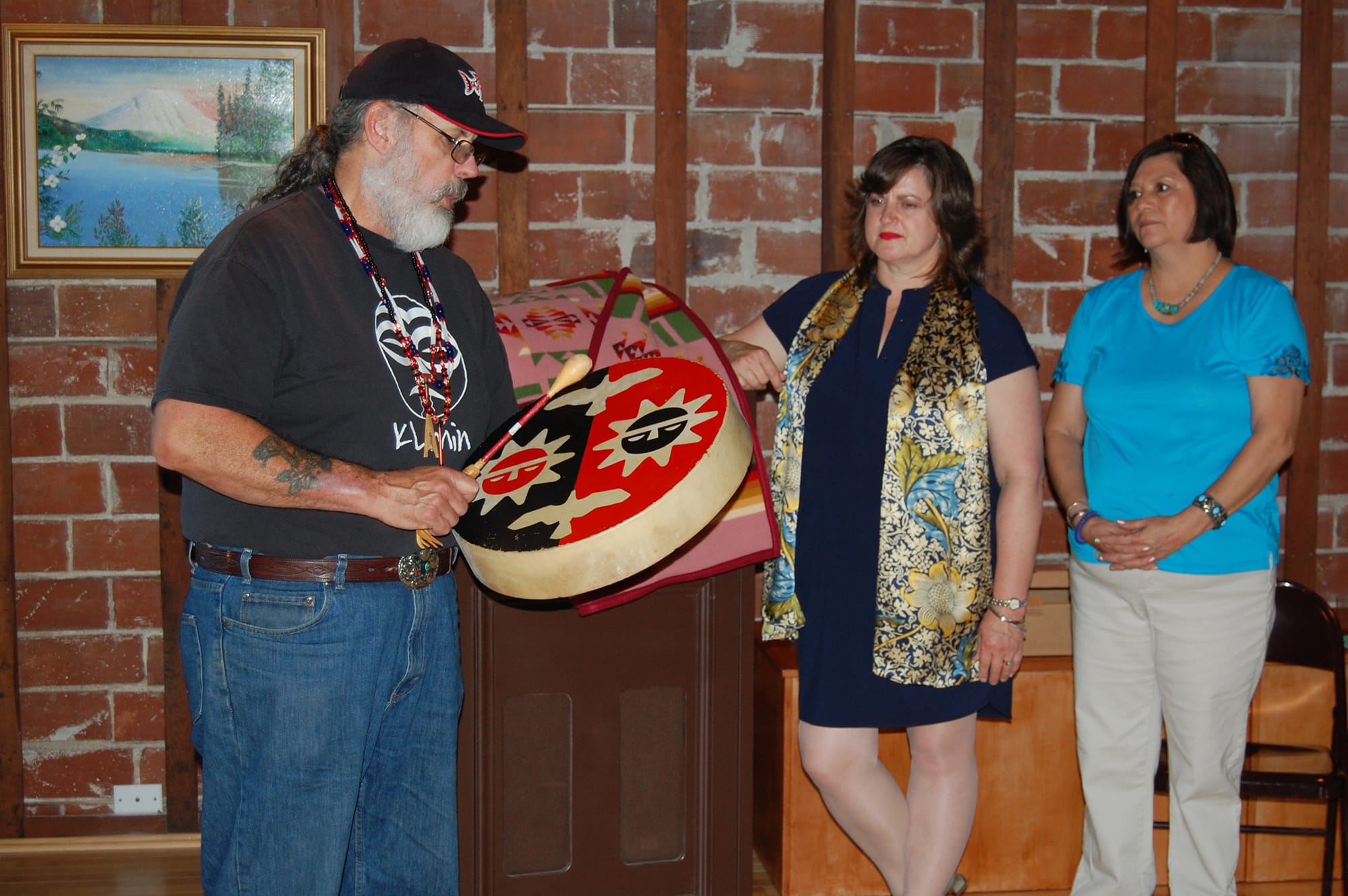 Arnada: Sam Robinson, left, vice chairman of the Chinook Nation, offers a traditional blessing for outgoing Clark County Historical Museum Executive Director Susan Tissot, center, during her farewell party on May 13.