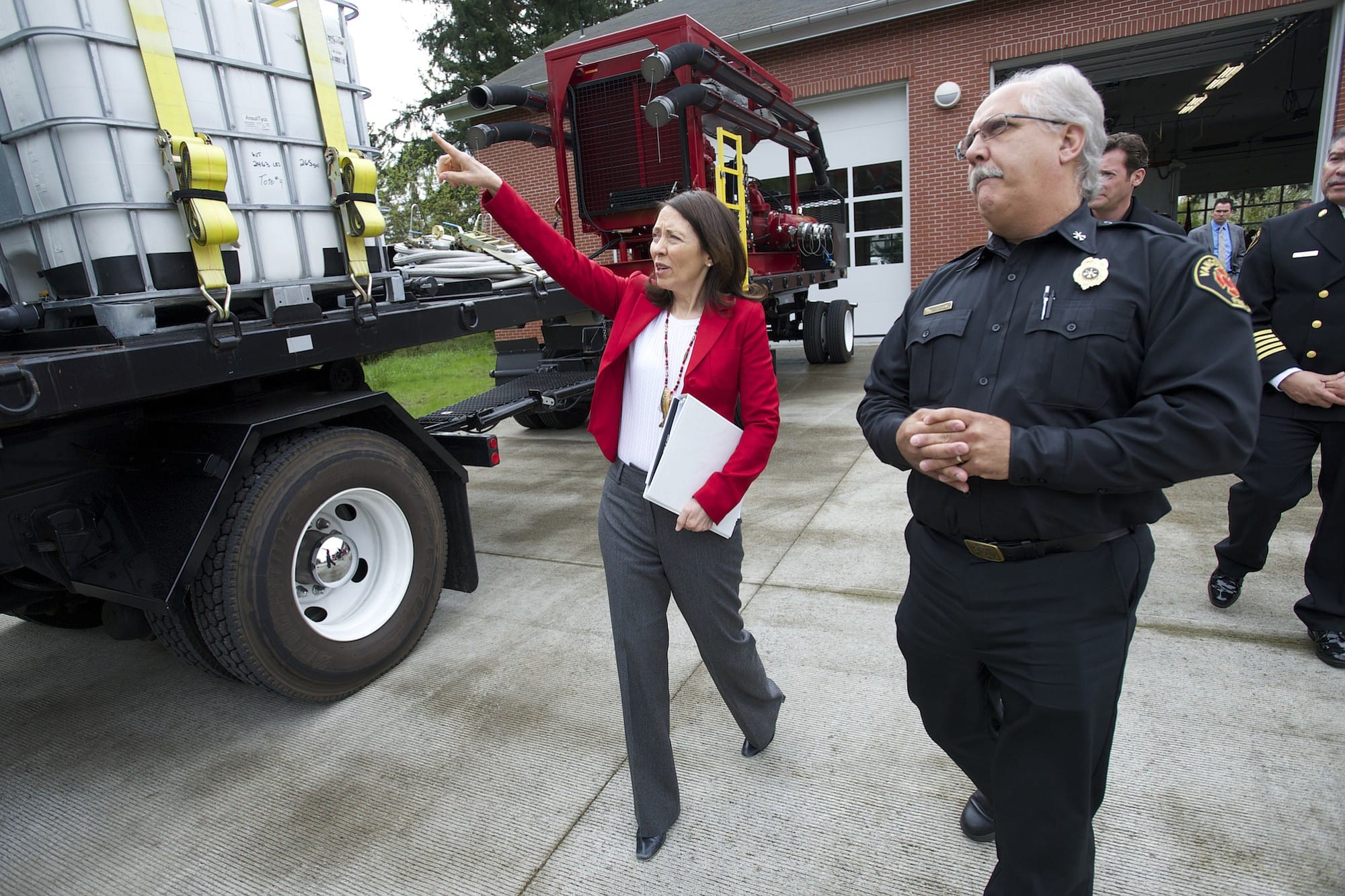 U.S. Sen. Maria Cantwell, D-Wash., walks past a firefighting rig with Vancouver Fire Department Division Chief Steve Eldred during a visit to Vancouver on Wednesday.