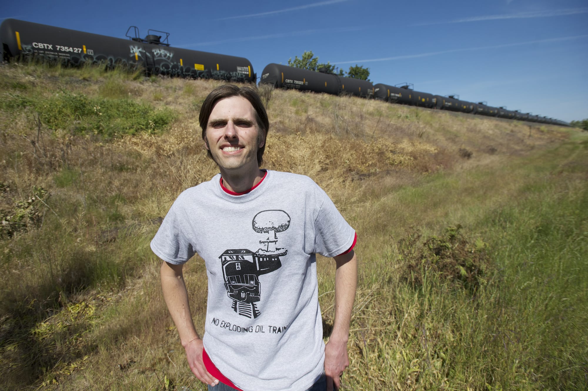 Matt Landon of Vancouver Action Network, shown Friday, has been leading efforts to track oil trains, including using rented equipment to record vapor emissions from tank cars and keeping tabs on the types of hazardous-materials trains, as shown by placards attached to the cars.