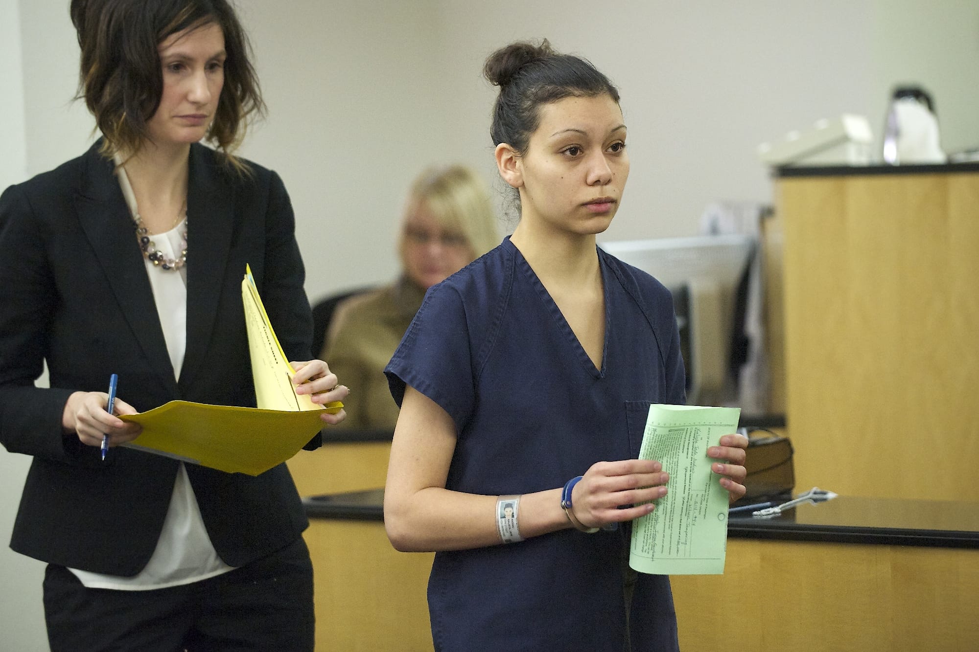 Attorney Megan Peyton, left, and Kalista Andino, 21, exit arraignment court in Vancouver.