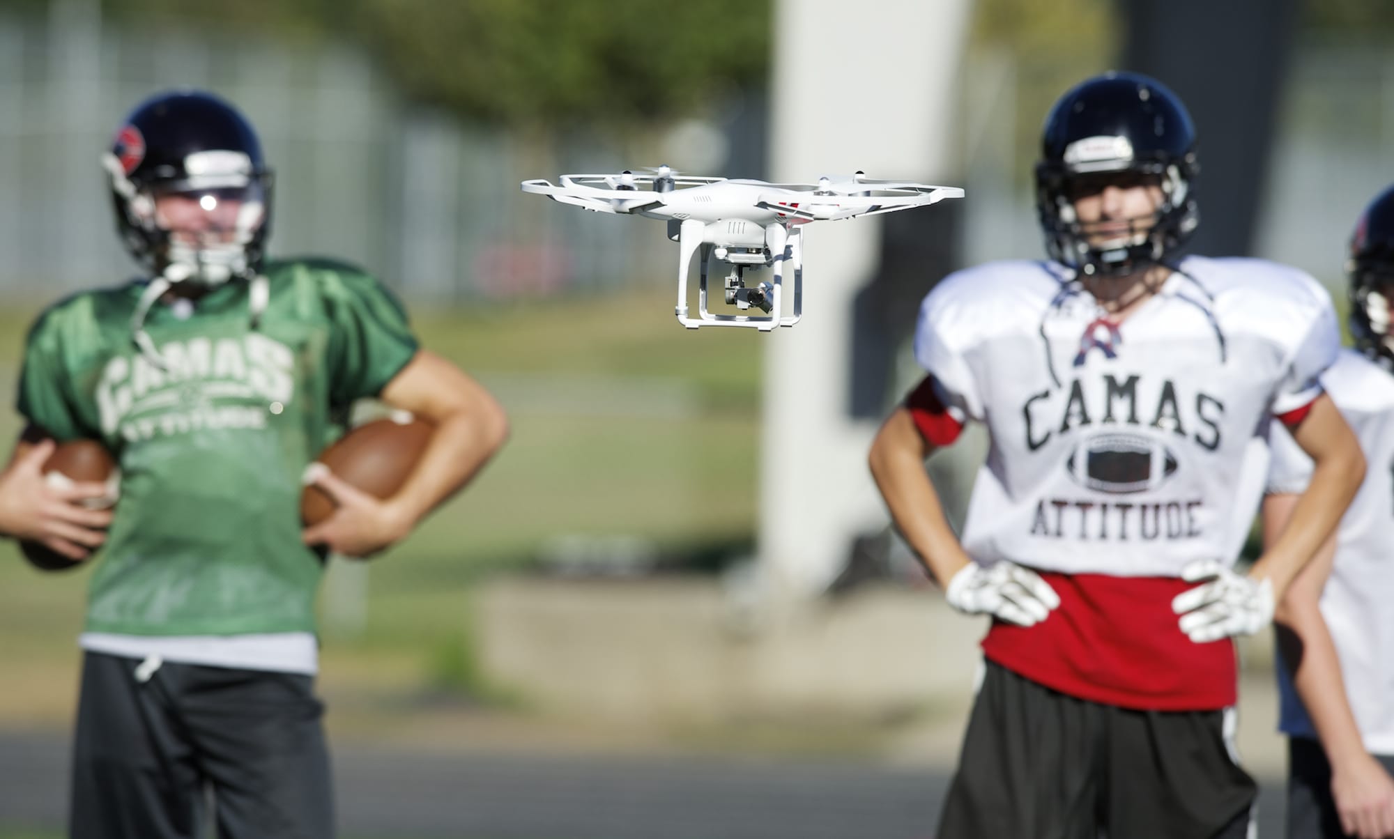 Parent volunteer Matt Codino pilots a drone to record football practice at Camas High School, Wednesday, September 10, 2014.