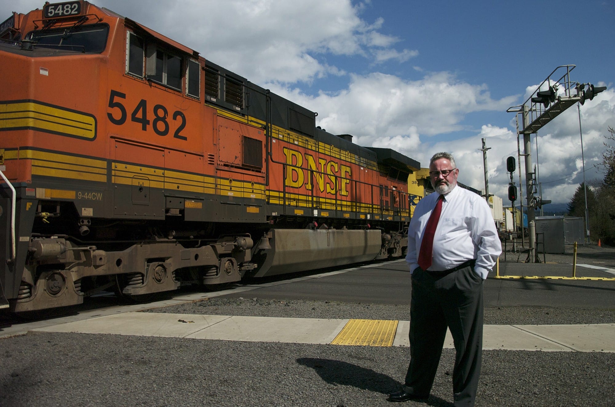 Washougal Mayor Sean Guard waits for a train to pass near the intersection of Main and 32nd streets.