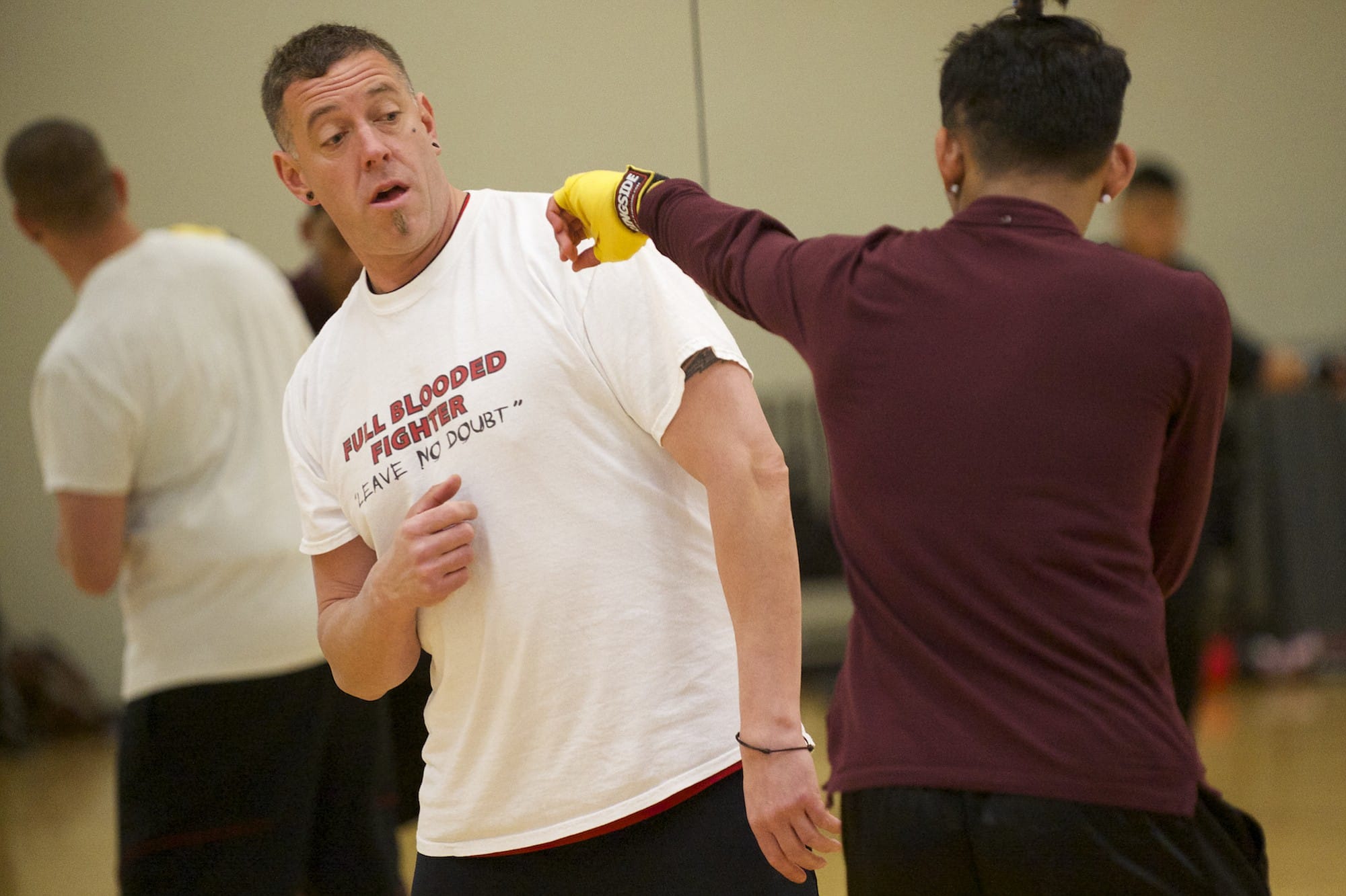 Tony Adams, founder of Mind Fitness Attitude Boxing instructs a boxing student during a Friday afternoon class at LA Fitness in Vancouver.