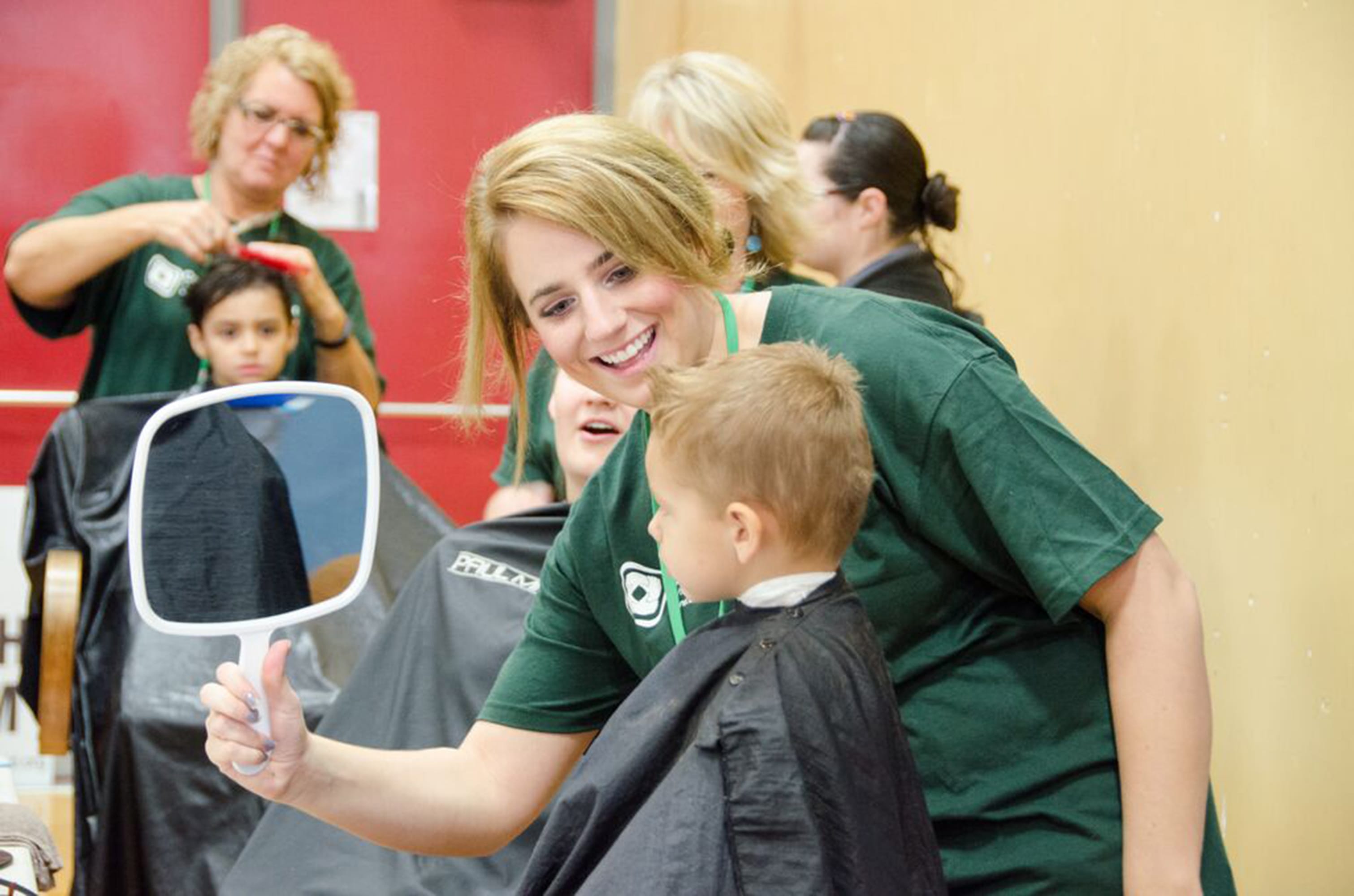 Hairstylists donated their time to provide free haircuts during the Compassion Ridgefield event at View Ridge Middle School last year. Stylists provided 92 free hair cuts during the 2014 event.