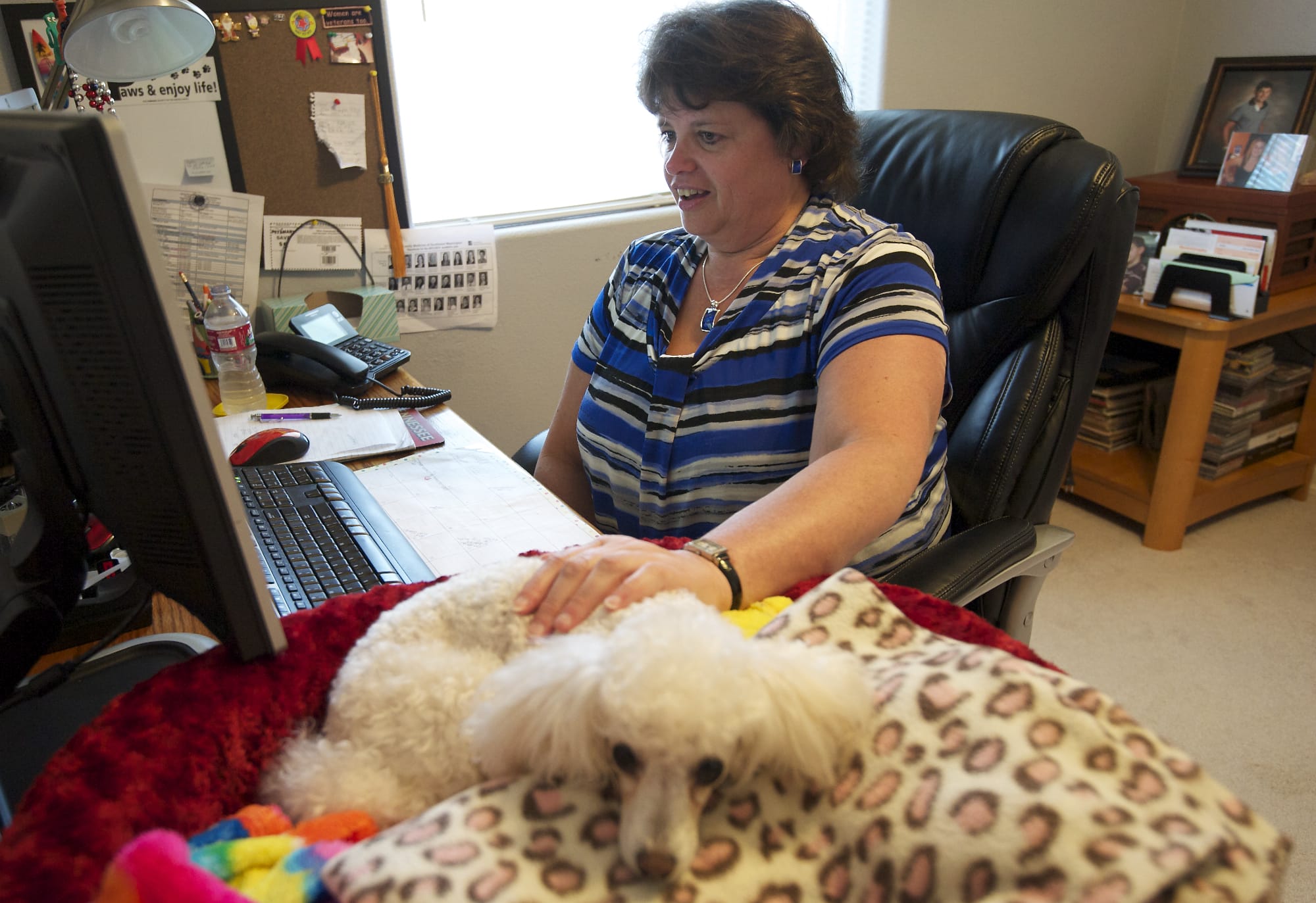 Tami Marshall has her dog Jazzy to keep her company during her workday at home. Marhsall is a medical coding specialist for Vancouver-based PeaceHealth, which allows its coders to work from home.