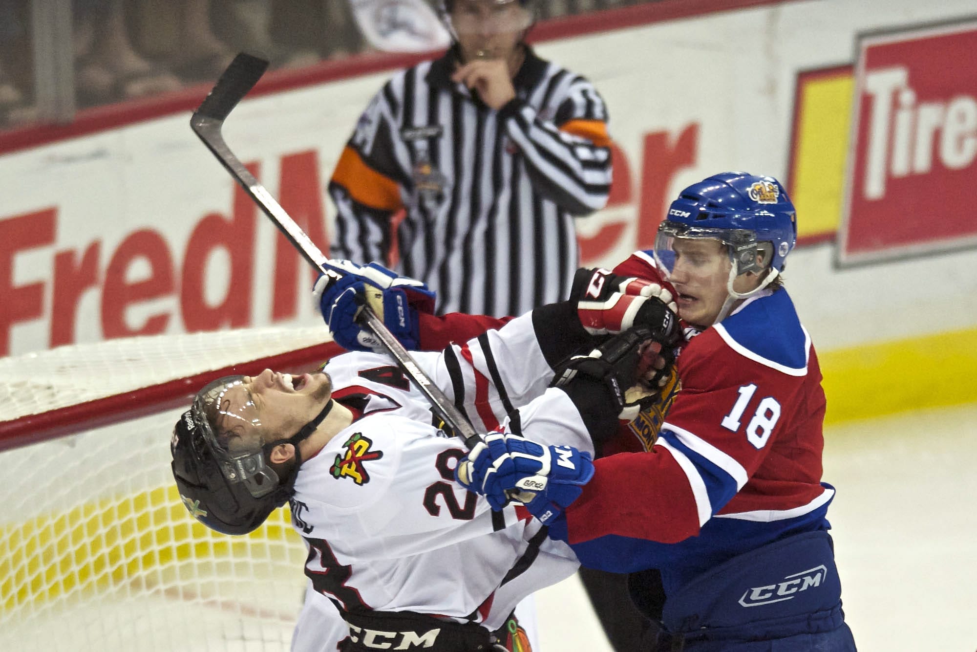 The Winterhawks' Brendan Leipsic takes a stick up high from the Oil Kings' Reid Petryk in the second period.