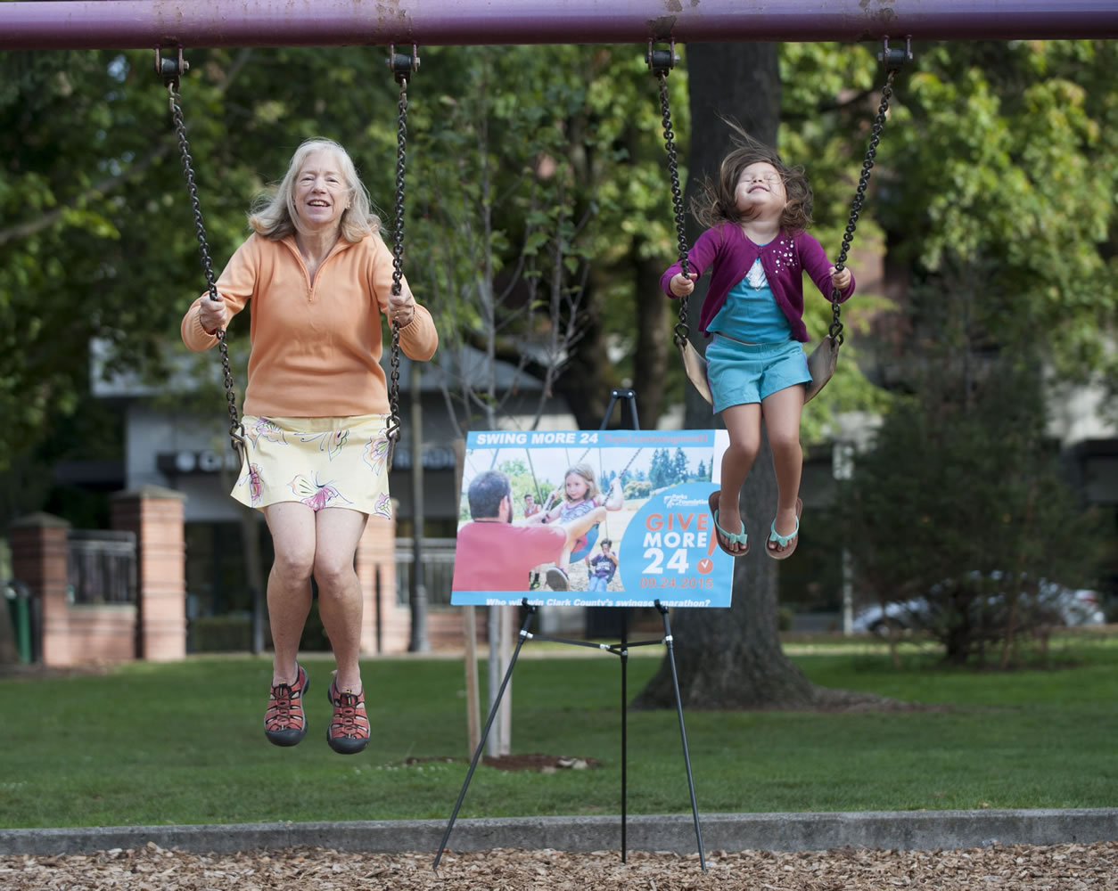 Jane Van Dyke, left, takes part in Give More 24! in a swinging marathon while Maxine Born-Bullock swings nearby in Vancouver on Thursday. The event is Clark County's annual 24-hour online giving competition, in which nonprofits encourage giving throughout the day with parties and promotions.