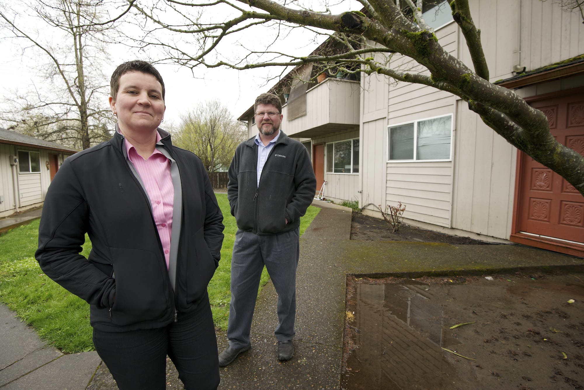 Kris Hanson, left, director of affordable housing for the Vancouver Housing Authority, and Craig Lyons, former director of the Council for the Homeless who now works for Key Property Services Inc., visit the Pinewood Terrace apartments on Kauffman Avenue.