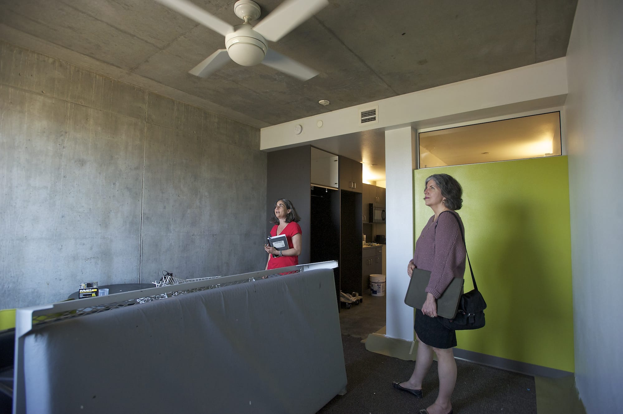 Bud Clark Commons property manager Rachel Duke, left, and public affairs director Shelley Marchesi give a tour of a vacant unit.