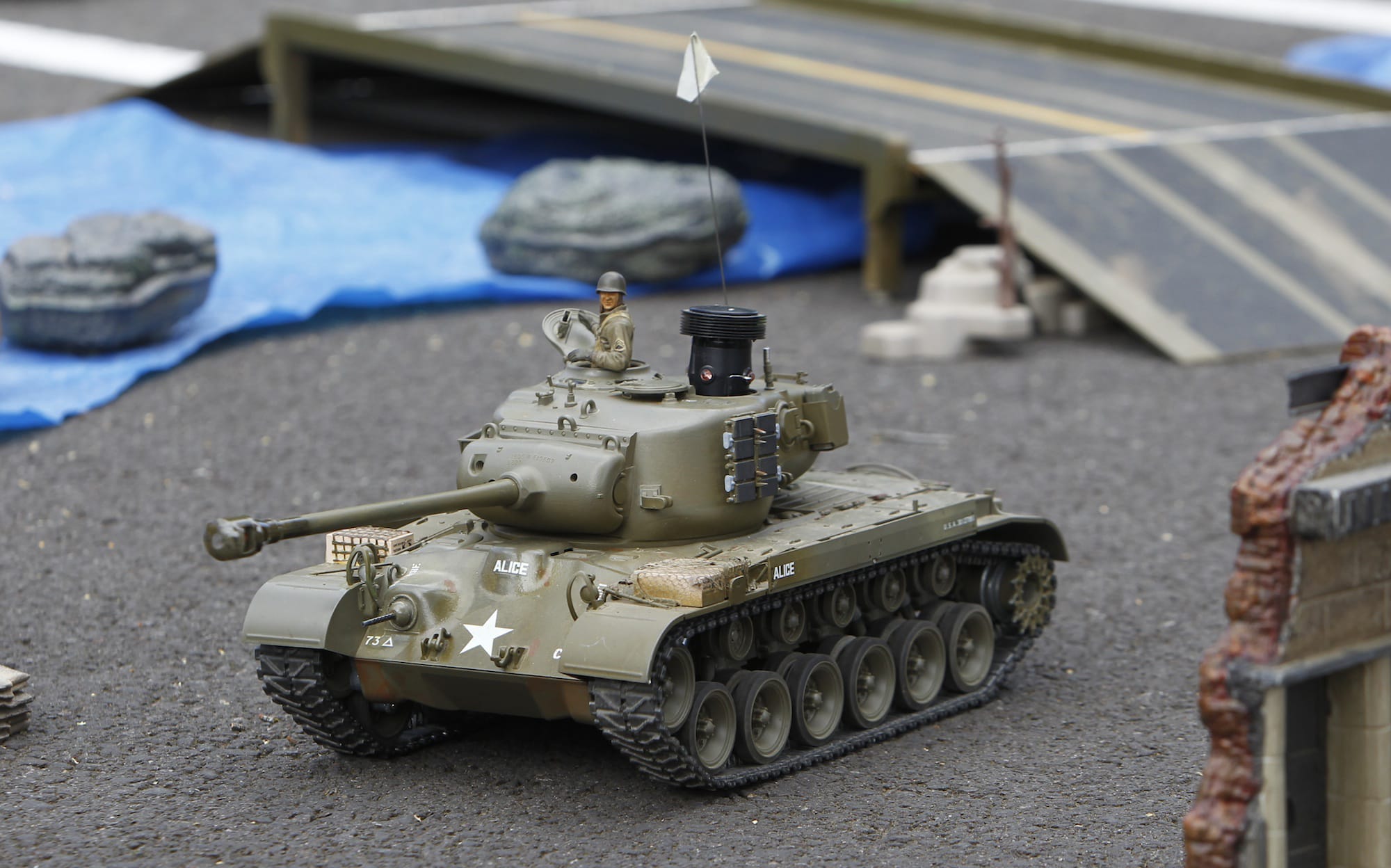 A remote control tank heads into battle at the Veterans Museum on Saturday.