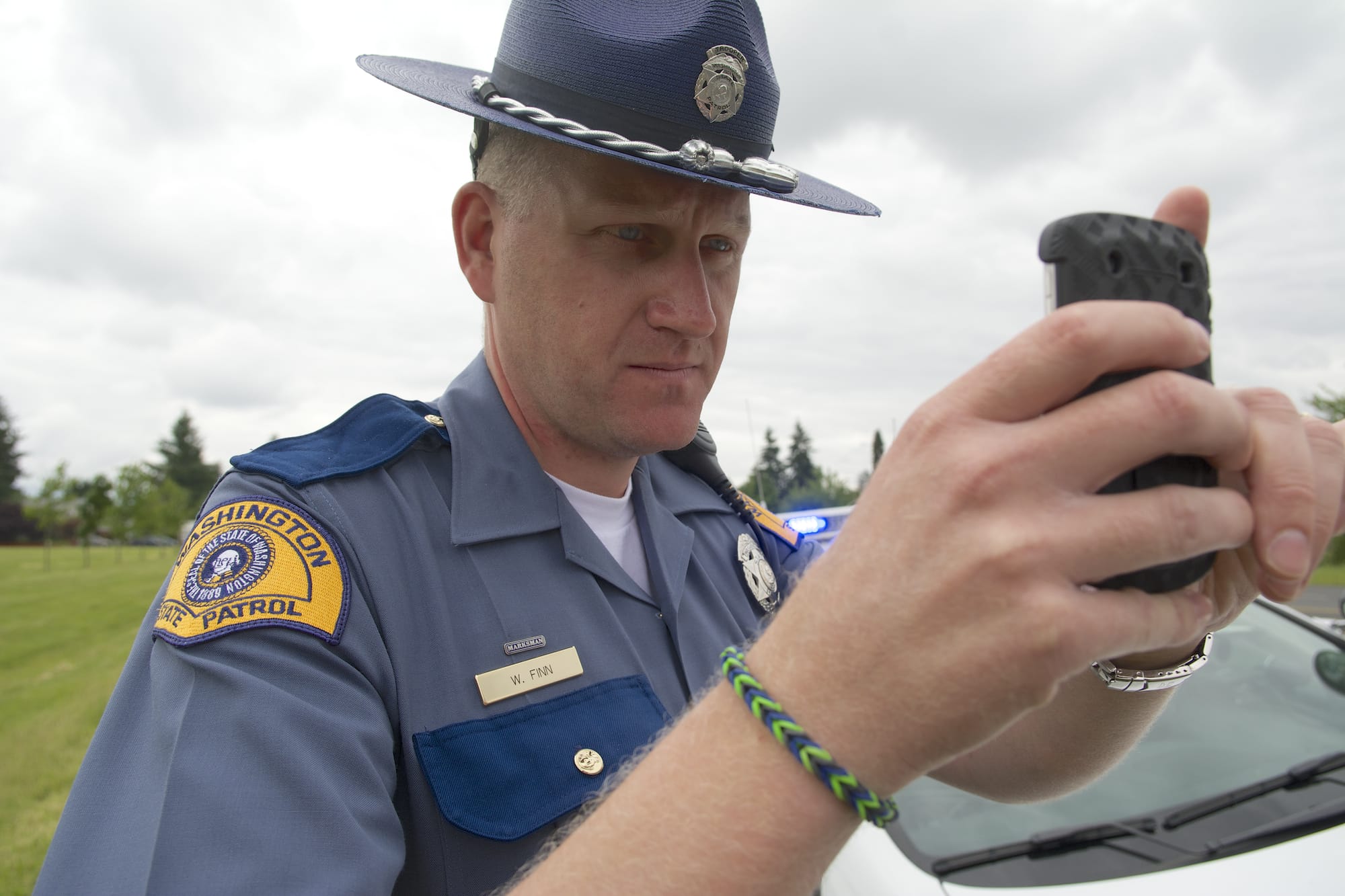 Washington State Patrol Trooper Will Finn takes a photo of a vehicle whose driver was not wearing a seat belt.