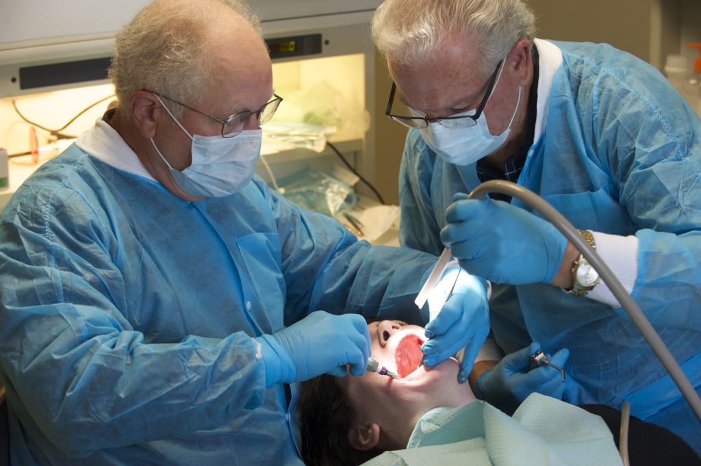 Drs. Glen Holler, left, and Gary Waldron provide dental care to Dana Duback de Sanchez at Battle Ground HealthCare Dental Clinic on in 2015.