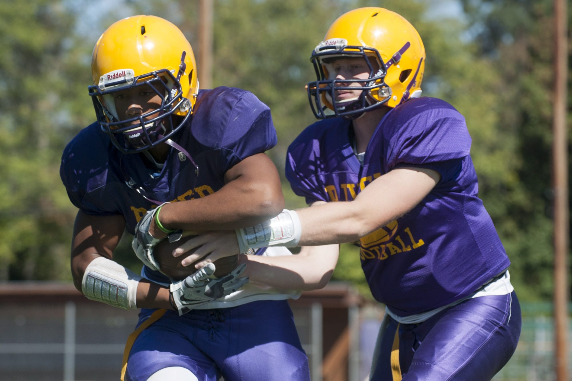Running back Travon Santiago (L) and Quarter back Garrett McKee at a football practice at Columbia River High School in Vancouver Monday August 25, 2015.