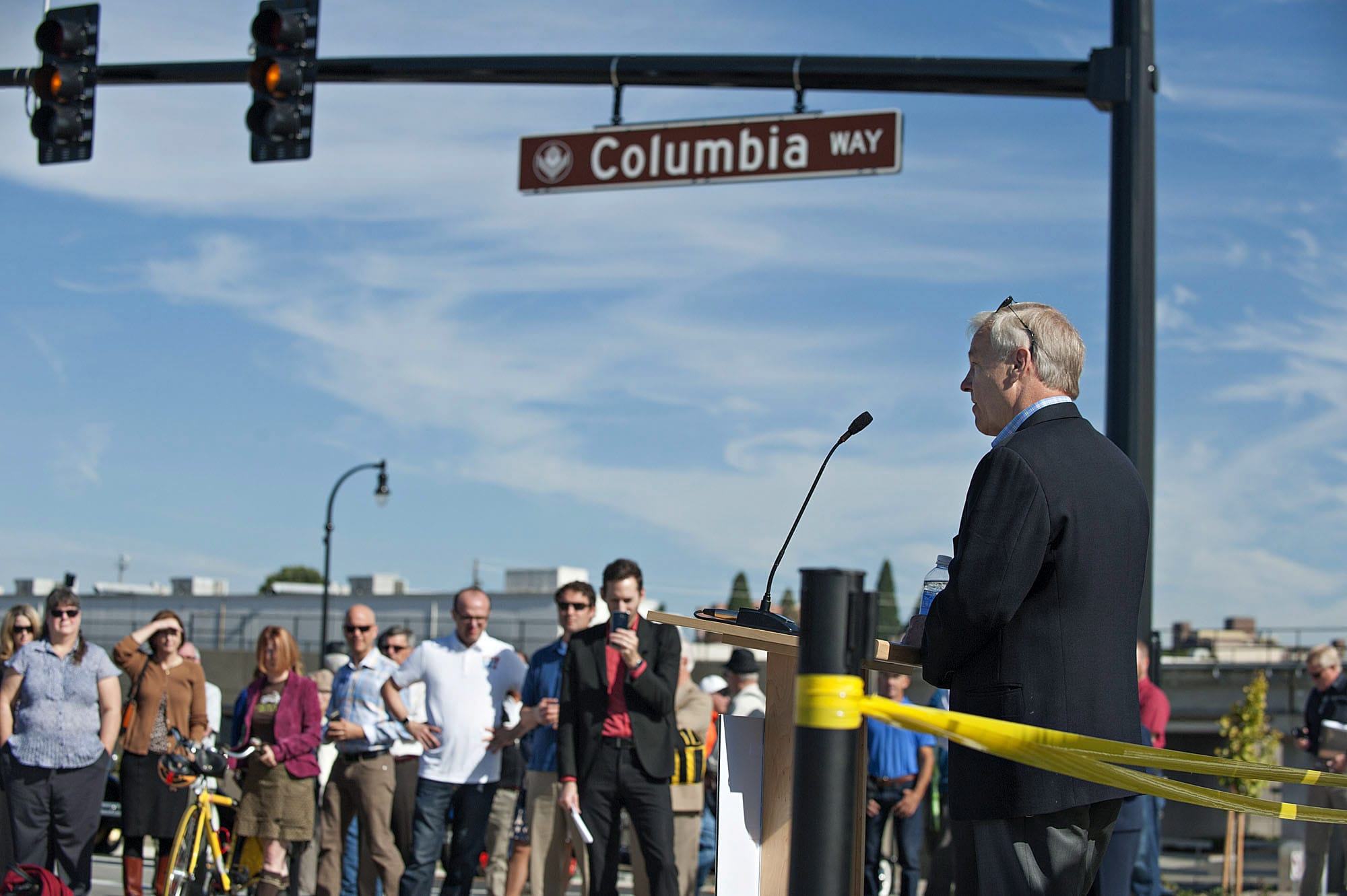 Barry Cain of Gramor Development speaks to the crowd along Columbia Way before the ribbon cutting Thursday morning, Sept. 24, 2015.