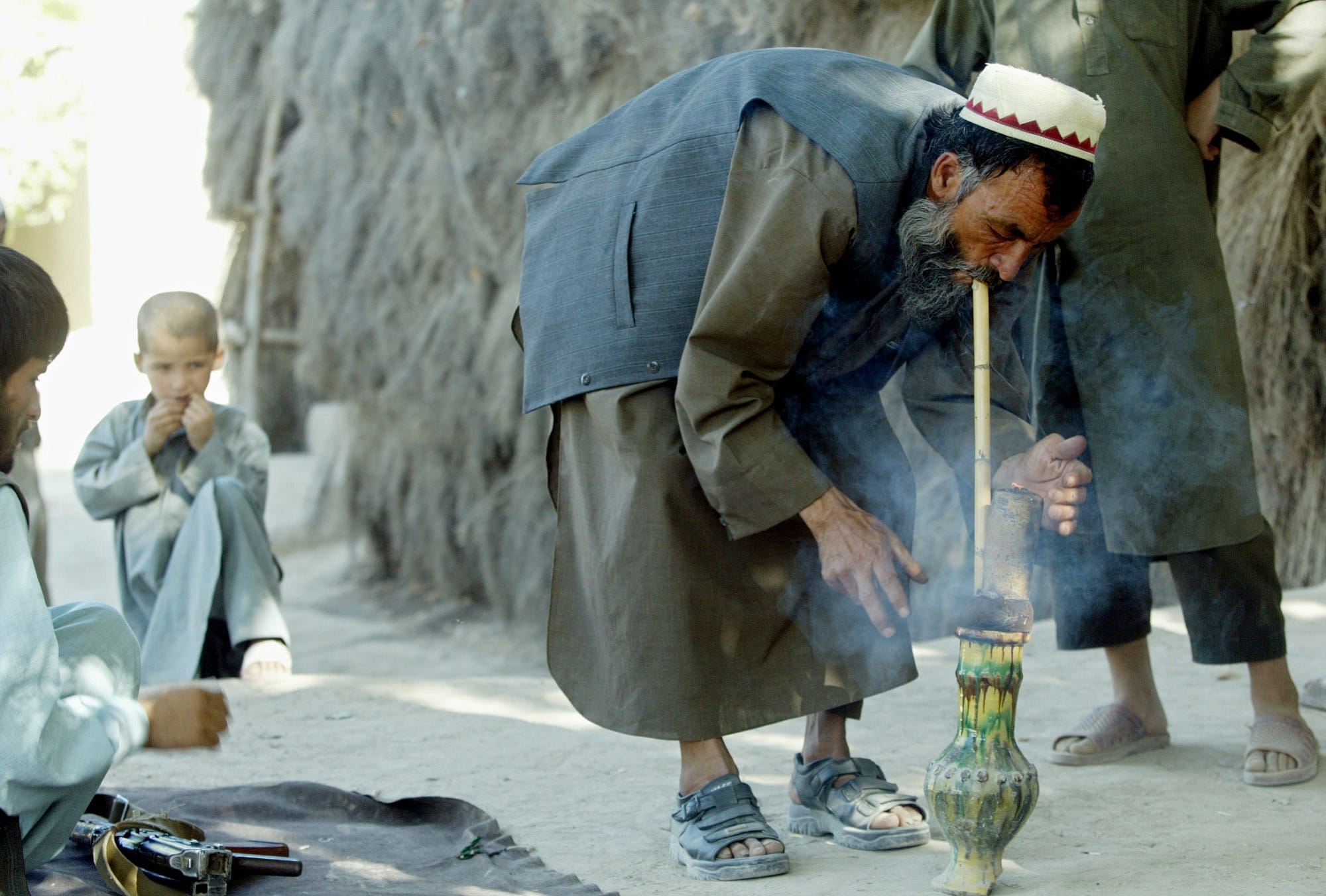 A farmer smokes hashish near the northern Afghan city of Mazar-e-Sharif on Sept. 11, 2002.