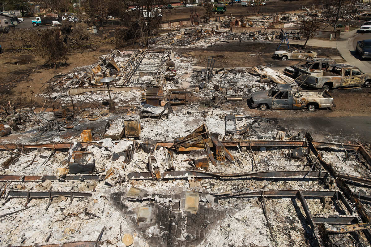 This photo shows remains of homes and vehicles scorched by a wildfire in Middletown, Calif., Monday, Sept. 21, 2015. Gov. Jerry Brown requested a presidential disaster declaration on Monday, noting that more than 1,000 homes had been confirmed destroyed, with the number likely to go higher as assessment continues.