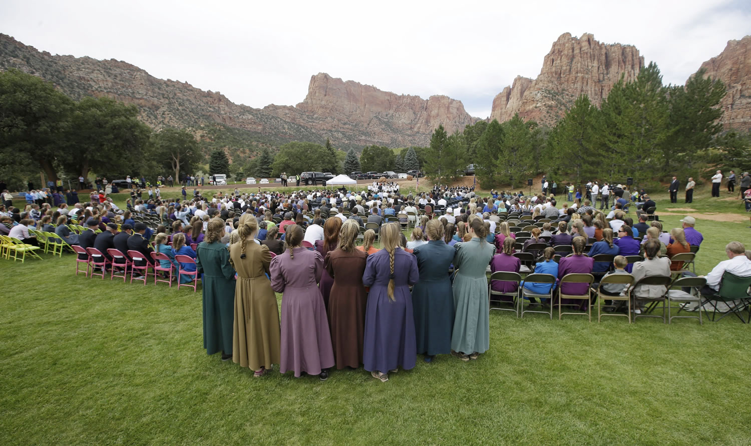 Community members from Hildale, Utah, and Colorado City, Ariz., attend a memorial service Saturday in Hildale for 12 women and children swept away in a deadly flash flood nearly two weeks earlier on the Utah-Arizona border. One 6-year-old boy is still missing.