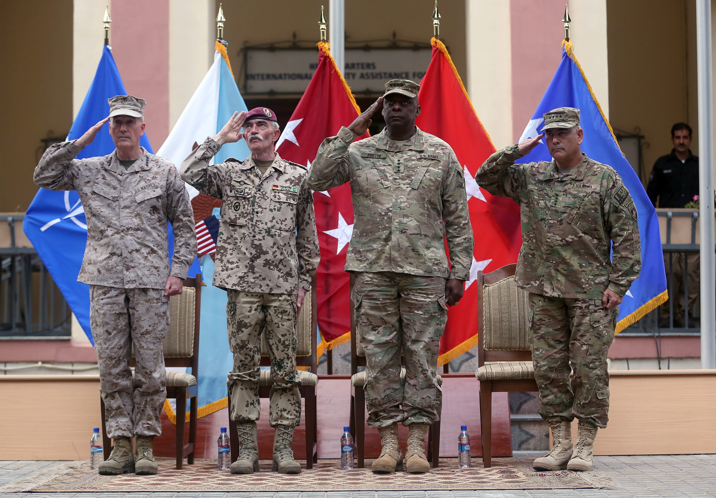 Outgoing commander of ISAF, U.S. Gen. Joseph Dunford, left, and incoming U.S. Army Commander for International Security Assistance Forces, Gen. John F. Campbell, right, salute during a change of command ceremony at the ISAF Headquarters in Kabul, Afghanistan, on Tuesday. ISAF is a NATO-led security mission in Afghanistan that was established by the United Nations Security Council in 2001.